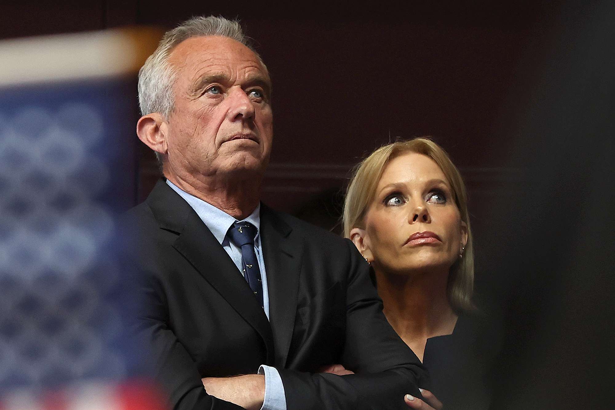 OAKLAND, CALIFORNIA - MARCH 26: Actress Cheryl Hines and her husband, Independent presidential candidate Robert F. Kennedy Jr., look on during a campaign event to announce his pick for a running mate at the Henry J. Kaiser Event Center on March 26, 2024 in Oakland, California. Independent presidential candidate Robert F. Kennedy Jr. announced Silicon Valley attorney Nicole Shanahan as his running mate