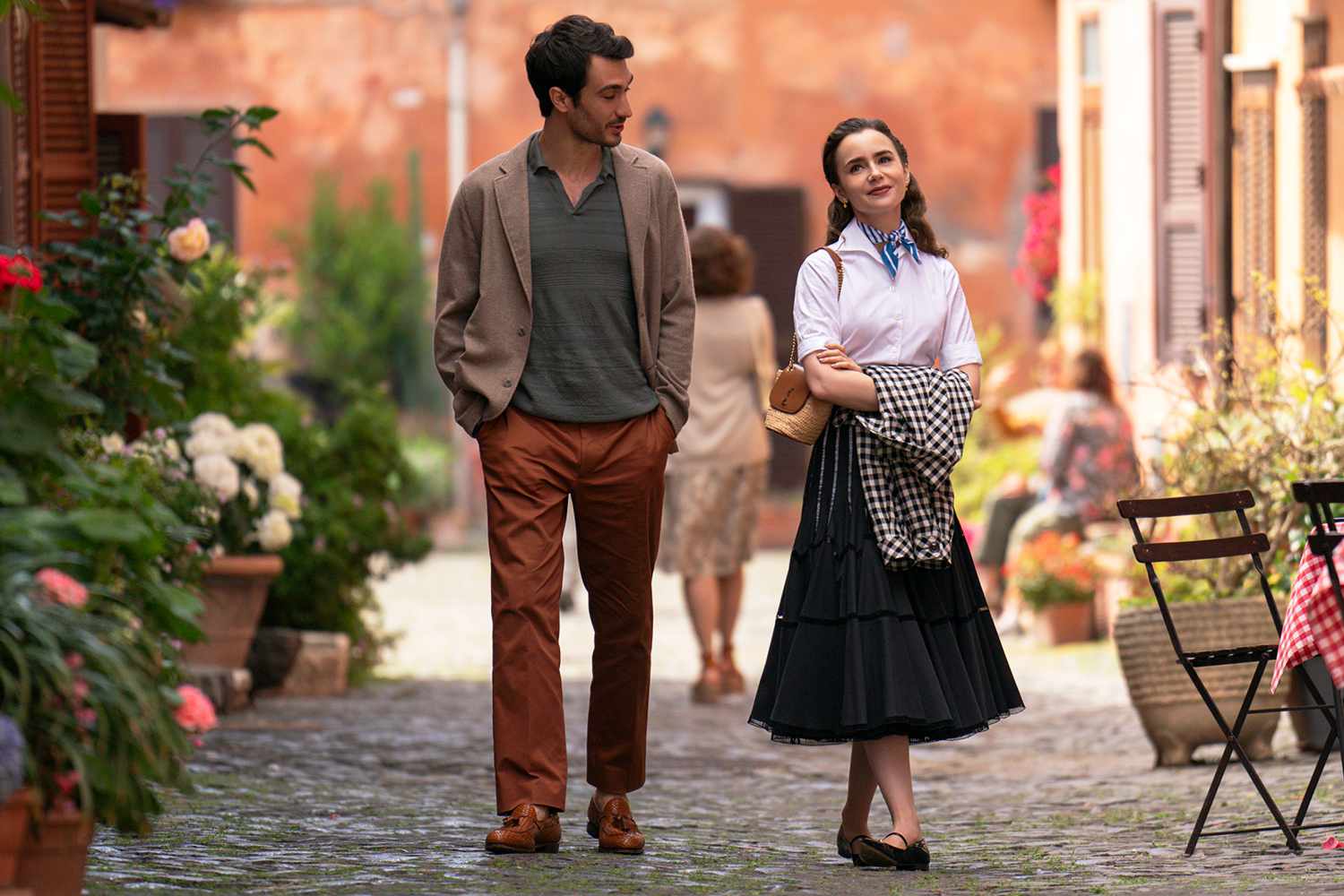 Eugenio Franceschini as Marcello and Lily Collins as Emily in episode 410 of Emily in Paris.