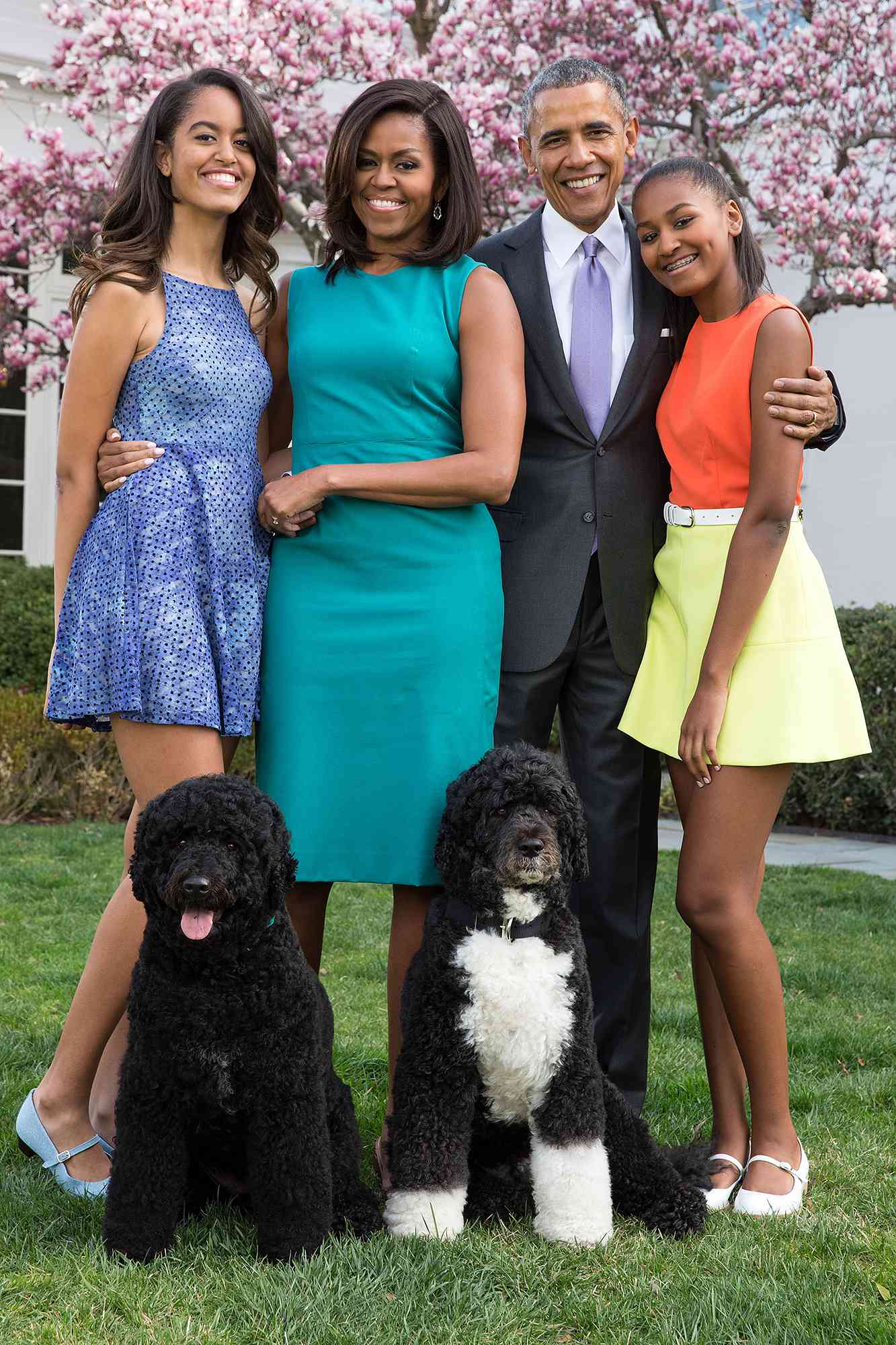 U.S. President Barack Obama, First Lady Michelle Obama, and daughters Malia (L) and Sasha (R) pose for a family portrait with their pets Bo and Sunny in the Rose Garden of the White House on Easter Sunday, April 5, 2015 in Washington, DC. 