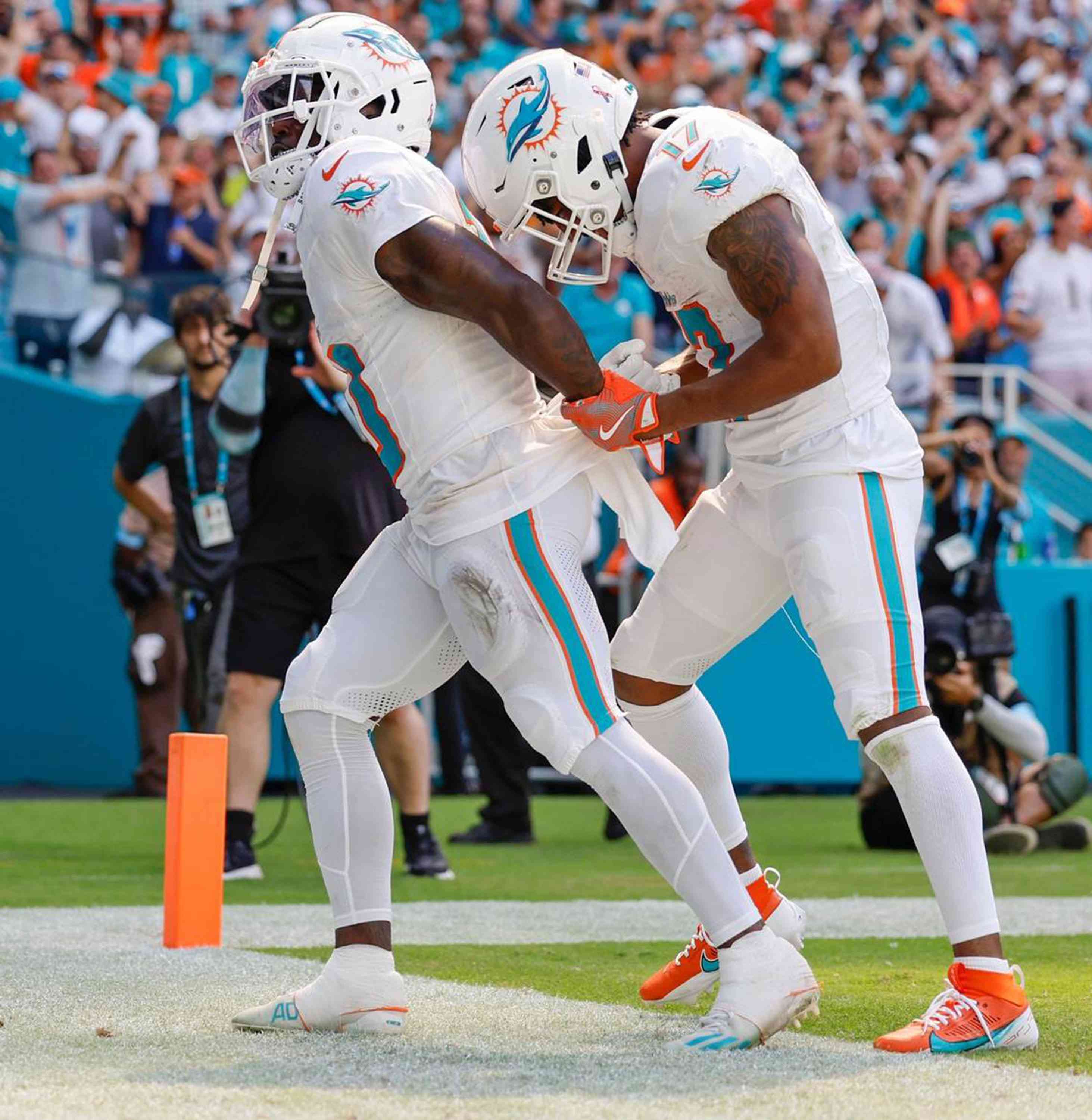 Miami Dolphins wide receiver Tyreek Hill (10) holds his hands behind his back as if he is handcuffed as wide receiver Jaylen Waddle (17) unlocks them after Waddle scores in the second half against the Jacksonville Jaguars at Hard Rock Stadium in Miami Gardens, Florida, on Sunday, Sept. 8, 2024