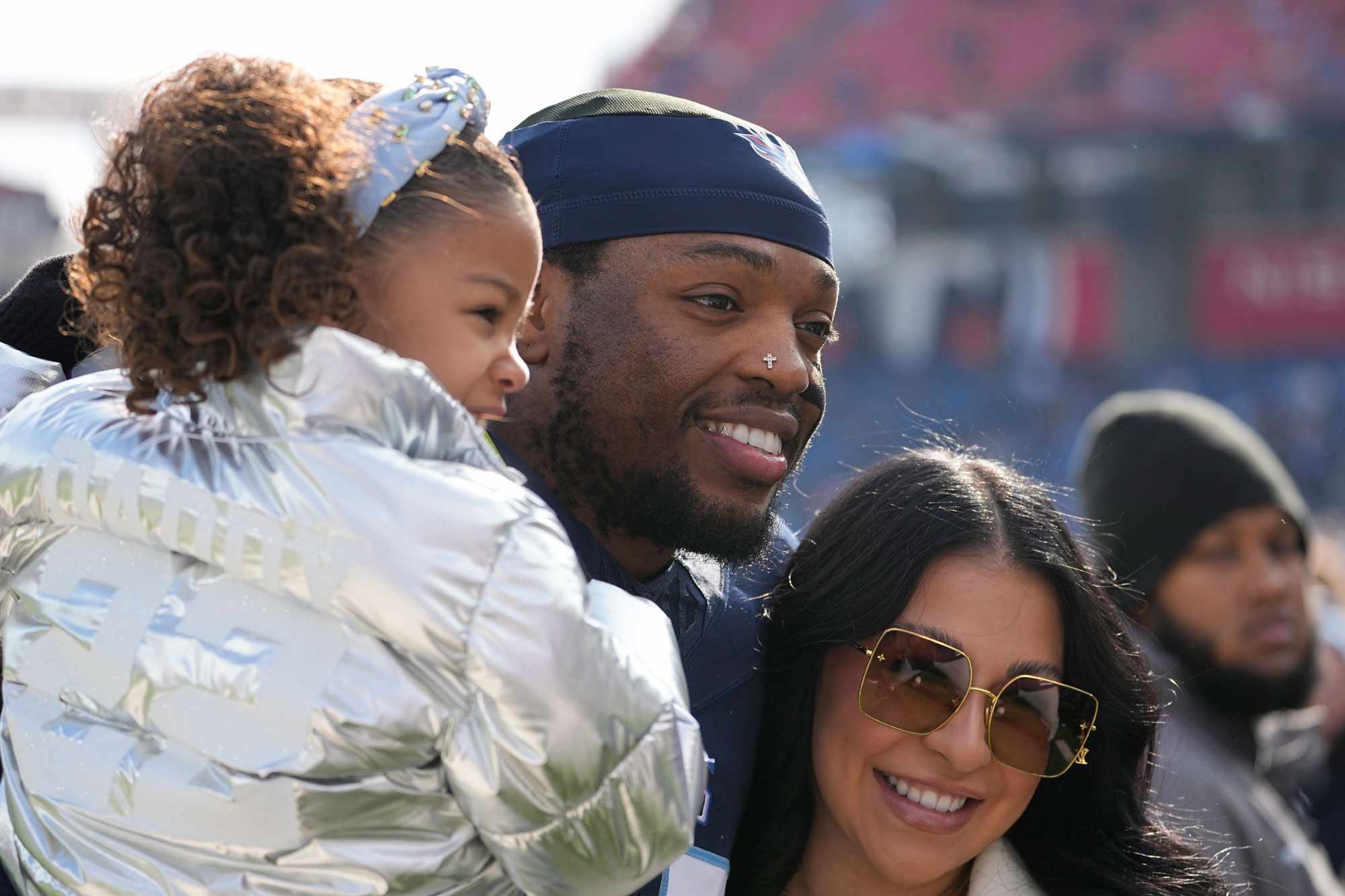 Tennessee Titans running back Derrick Henry, center, poses with his girlfriend Adrianna Rivas, right, and his daughter Valentina Henry, left, before an NFL football game Sunday, Jan. 7, 2024, in Nashville, Tenn. (AP Photo/George Walker IV)