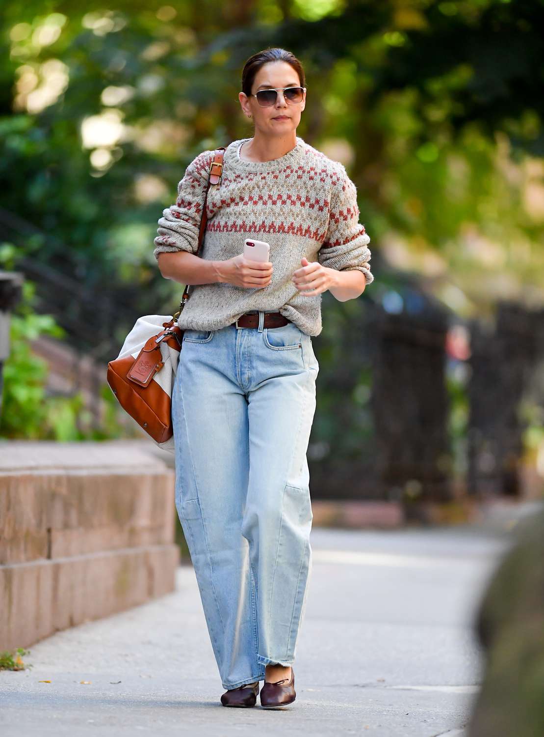 Katie Holmes is pictured stepping out in New York City. The American actress carried a Tusting Como Explorer tote bag and wore an A.P.C sweater, jeans, and a pair of flats.