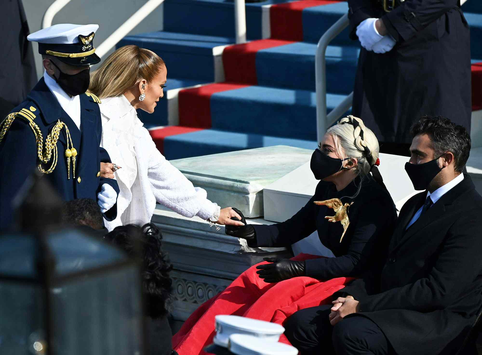 Jennifer Lopez greets Lady Gaga (R) flanked by Michael Polansky at the 59th Presidential Inaguruation in Washington, DC