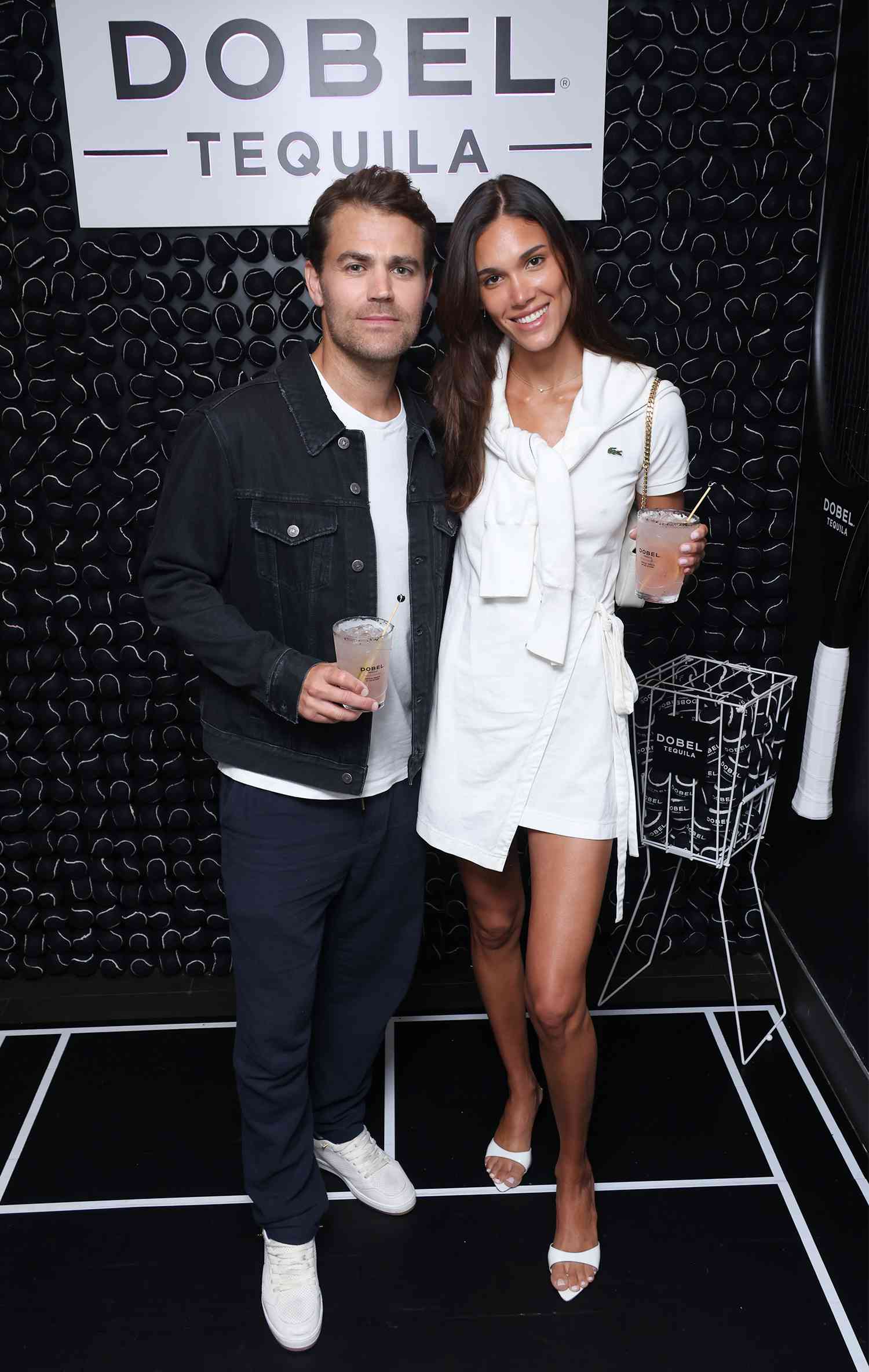 Paul Wesley and Natalie Kuckenburg enjoy a Dobel Tequila Ace Paloma cocktail at the 2024 US Open with Maestro Dobel Tequila