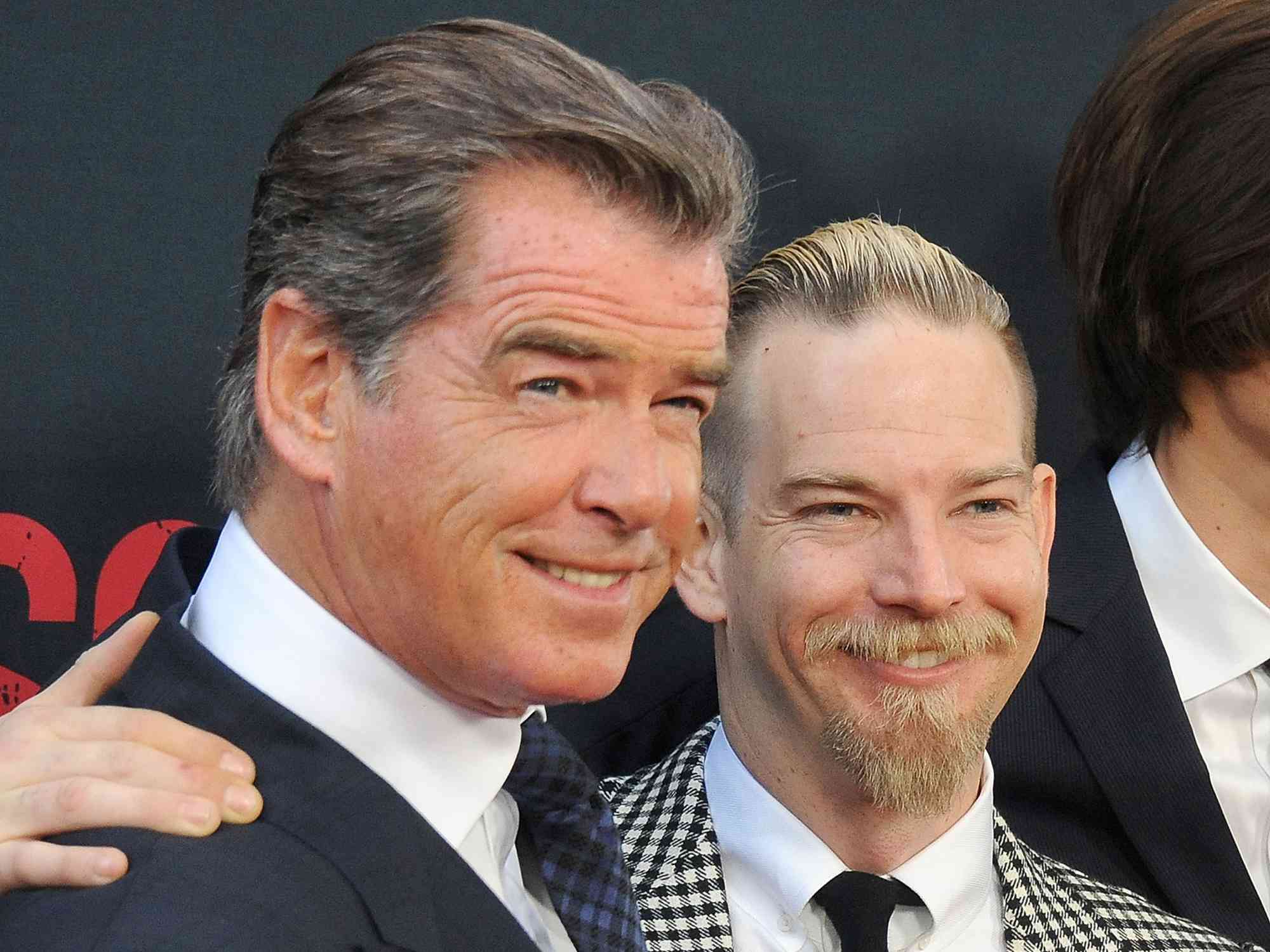 Pierce Brosnan and son Sean Brosnan arrive at the premiere of The Weinstein Company's "No Escape" at Regal Cinemas L.A. Live on August 17, 2015 in Los Angeles, California