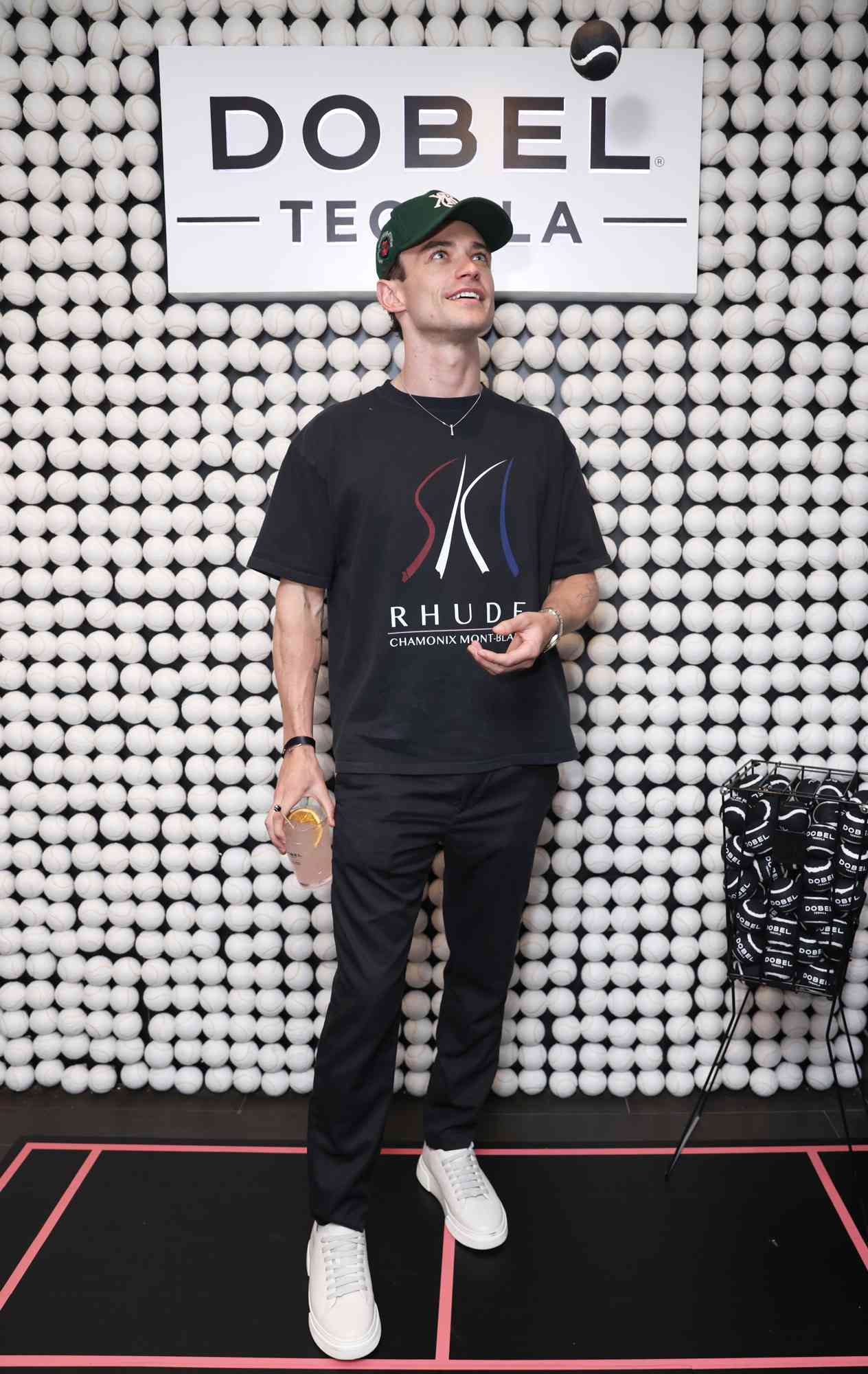 Thomas Doherty enjoys a Dobel Tequila cocktail at the 2024 US Open with Maestro Dobel Tequila, the Official Tequila of The US Open, at the USTA Billie Jean King National Tennis Center on August 27, 2024 in New York City