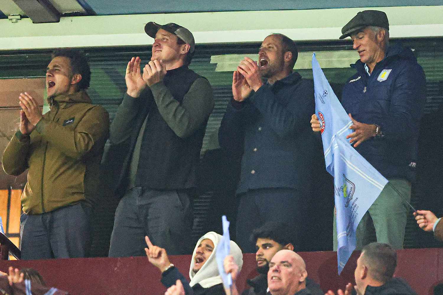 HRH William, Prince of Wales, celebrates Aston Villa's victory with Harry Aubrey-Fletcher (R), Edward van Cutsem (M-L), and Thomas van Straubenzee (L) - childhood friends of Prince William and godparents to his children - on the final whistle during the UEFA Champions League 2024/25 League Phase MD2 match between Aston Villa FC and FC Bayern