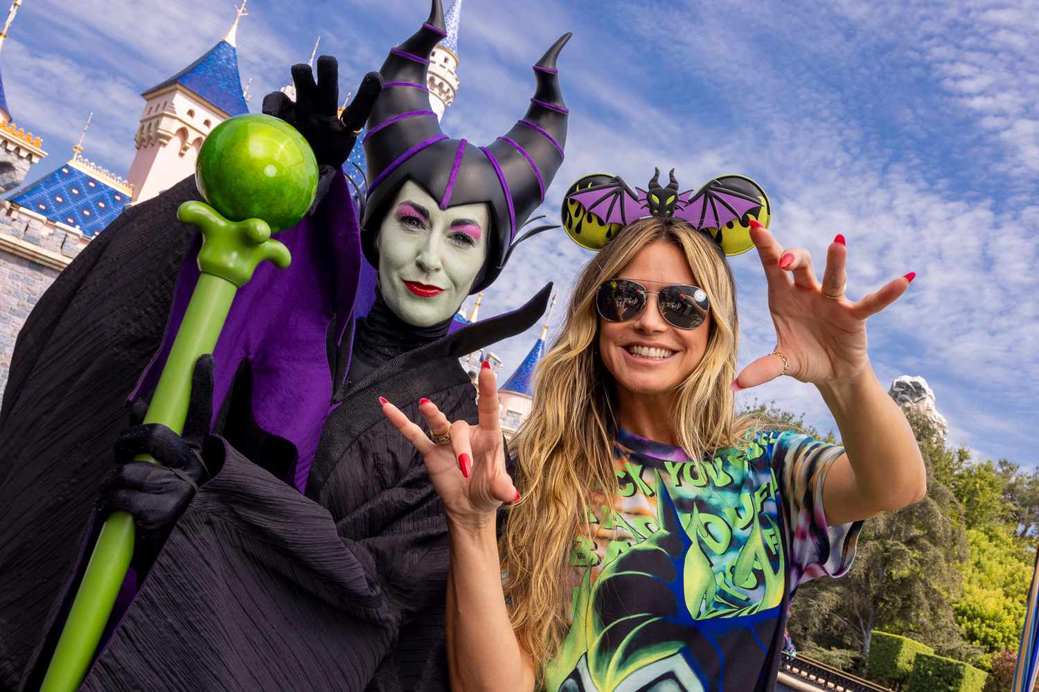 Heidi Klum (R) poses with Maleficent in front of Sleeping Beauty Castle at Disneyland Park in Anaheim, California