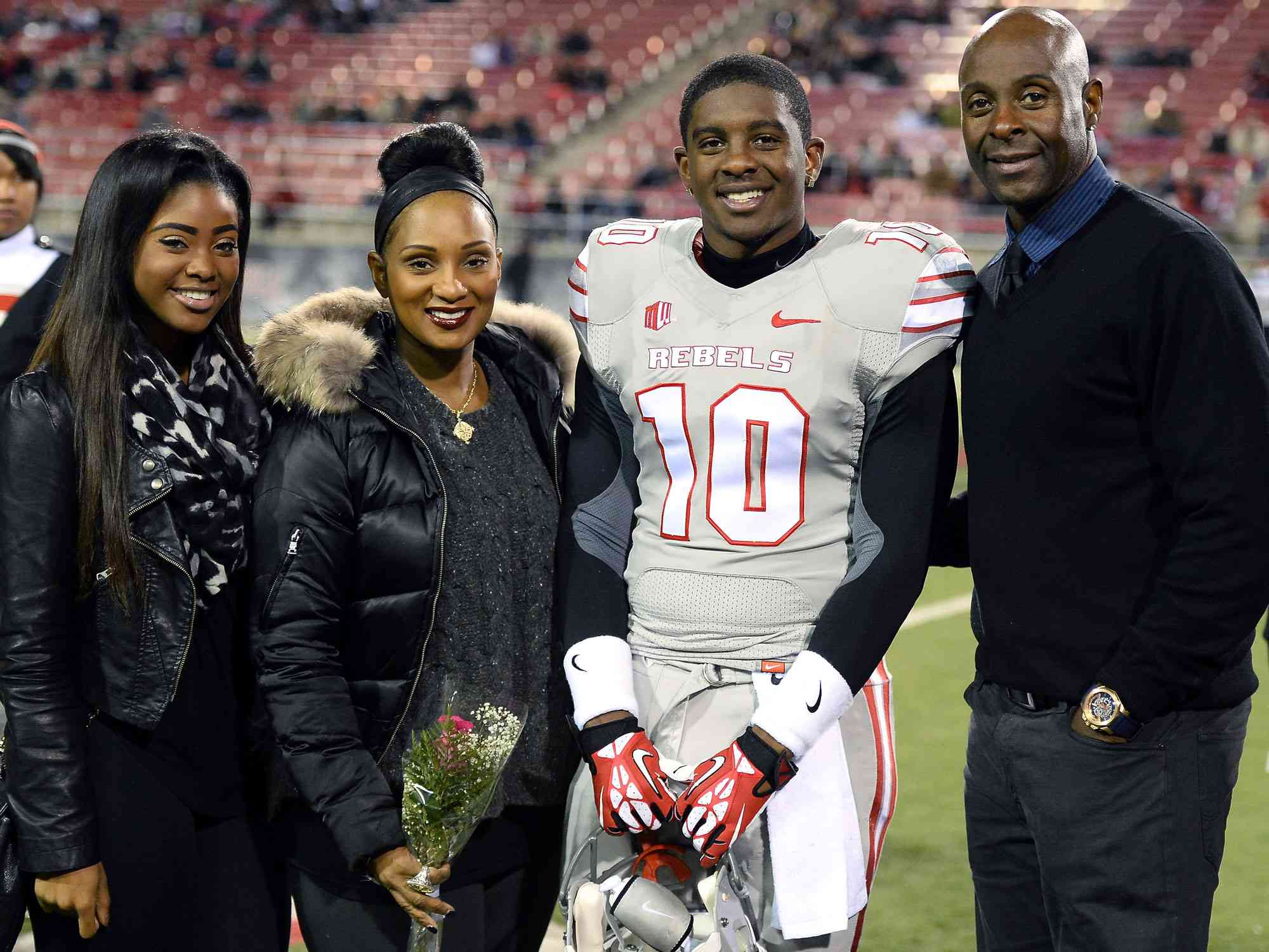 LAS VEGAS, NV - NOVEMBER 30: Jerry Rice Jr. #10 of the UNLV Rebels poses with (L-R) his sister Jada Rice, his mother Jackie Rice and his father, Hall of Fame National Football League player Jerry Rice, during senior night festivities on the field before UNLV's game against the San Diego State Aztecs at Sam Boyd Stadium on November 30, 2013 in Las Vegas, Nevada. (Photo by Ethan Miller/Getty Images)