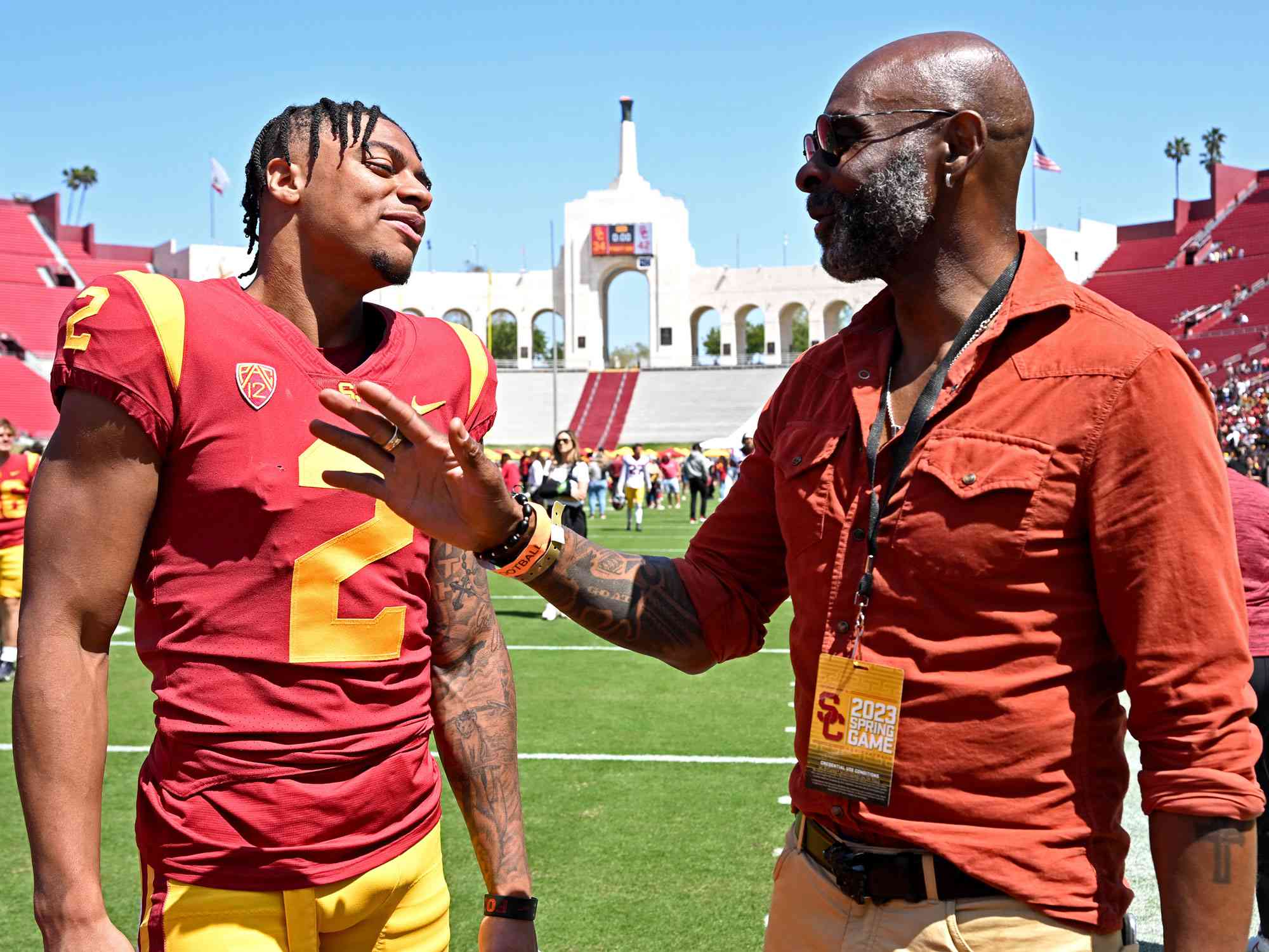 LOS ANGELES, CA - APRIL 15: Former pro football player and member of the Pro Football Hall of Fame, Jerry Rice, talks with his son, Brenden Rice #2 of the USC Trojans, following the spring football game at the Los Angeles Memorial Coliseum on April 15, 2023 in Los Angeles, California. (Photo by Jayne Kamin-Oncea/Getty Images)