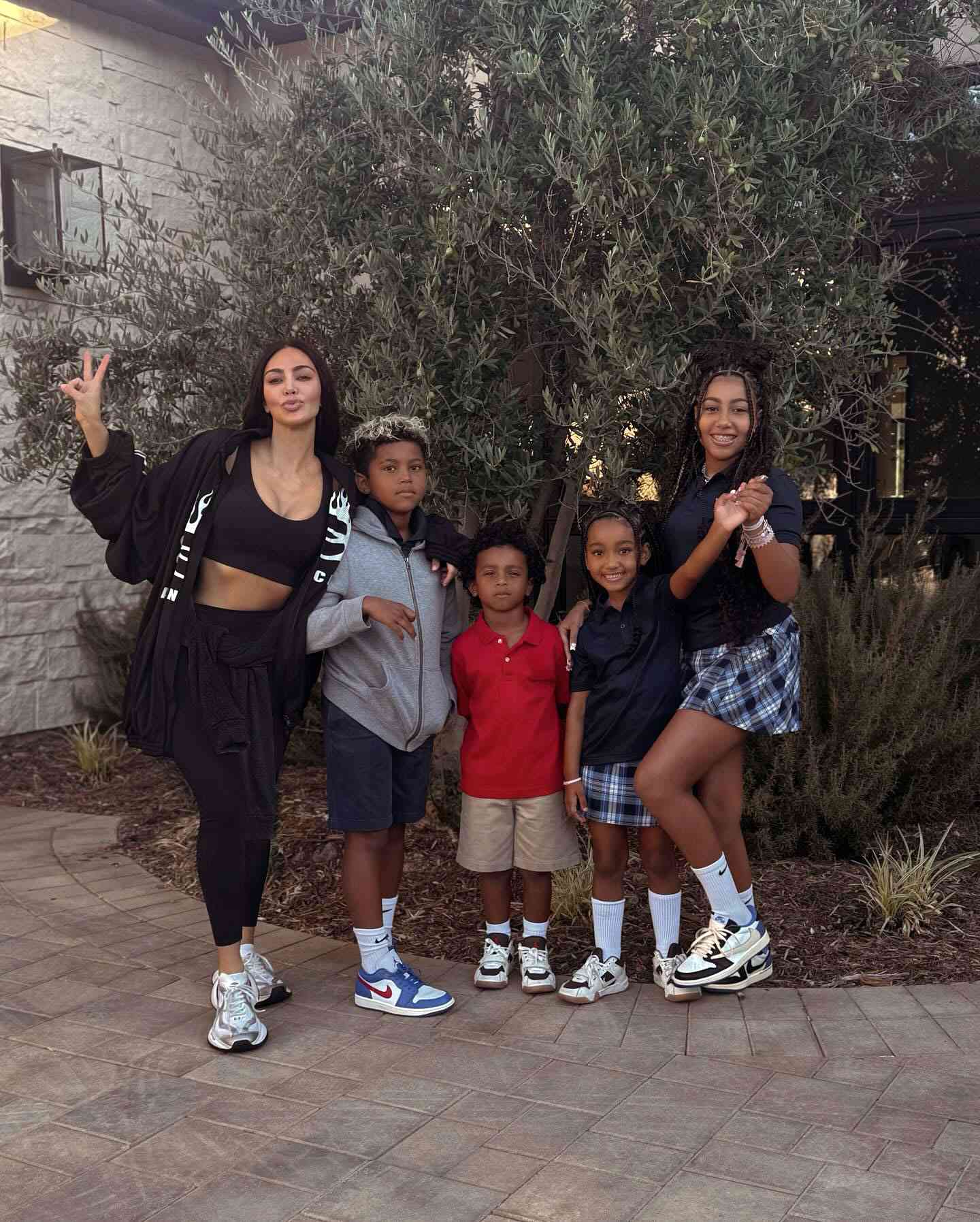 Kim Kardashian poses with her kids at home. Saint West, Psalm West, Chicago West, and North West.