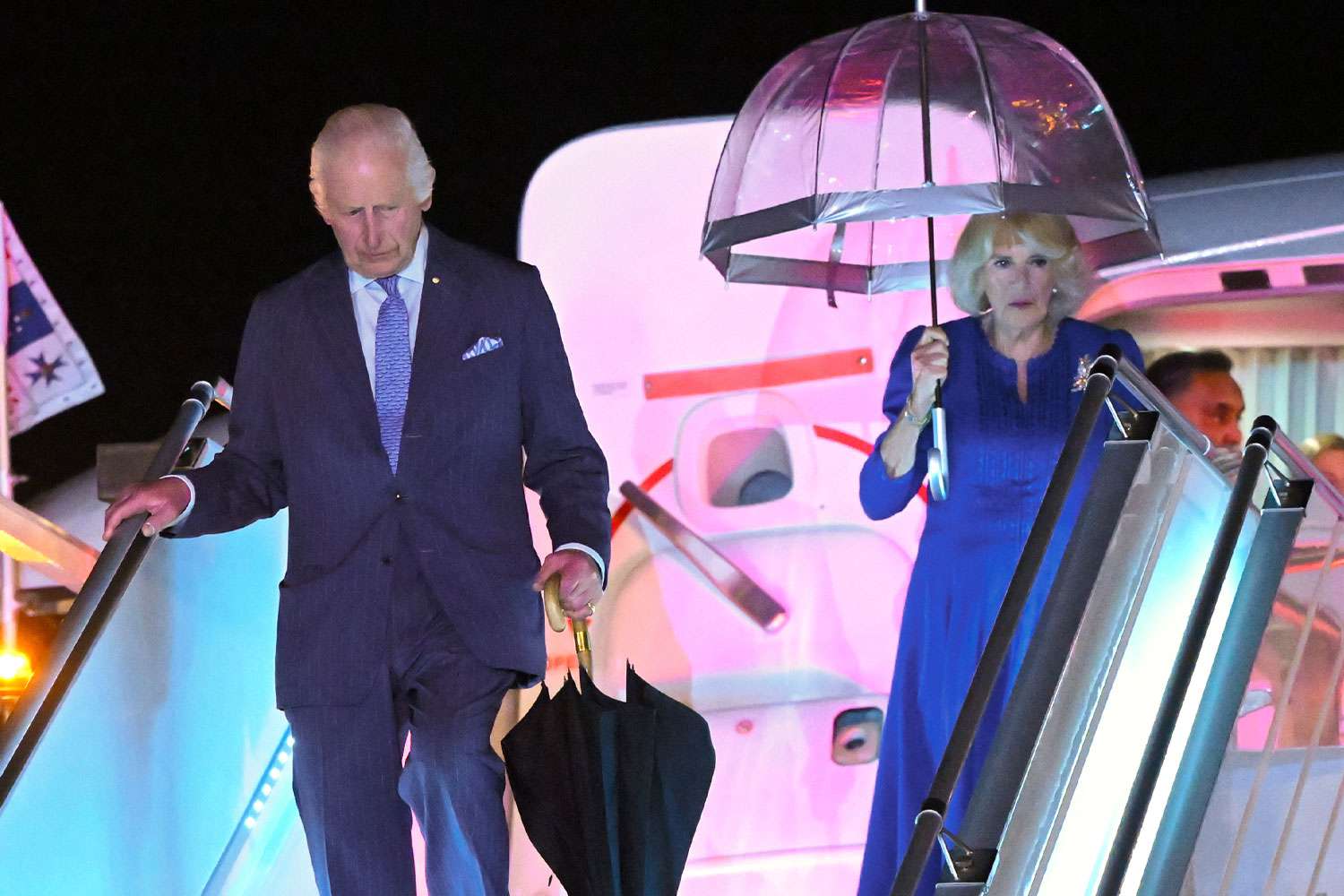 : King Charles III and Queen Camilla disembark their airplane as they arrive at Sydney Airport on October 18, 2024 in Sydney, Australia. The King's visit to Australia will be his first as Monarch, and CHOGM in Samoa will be his first as Head of the Commonwealth