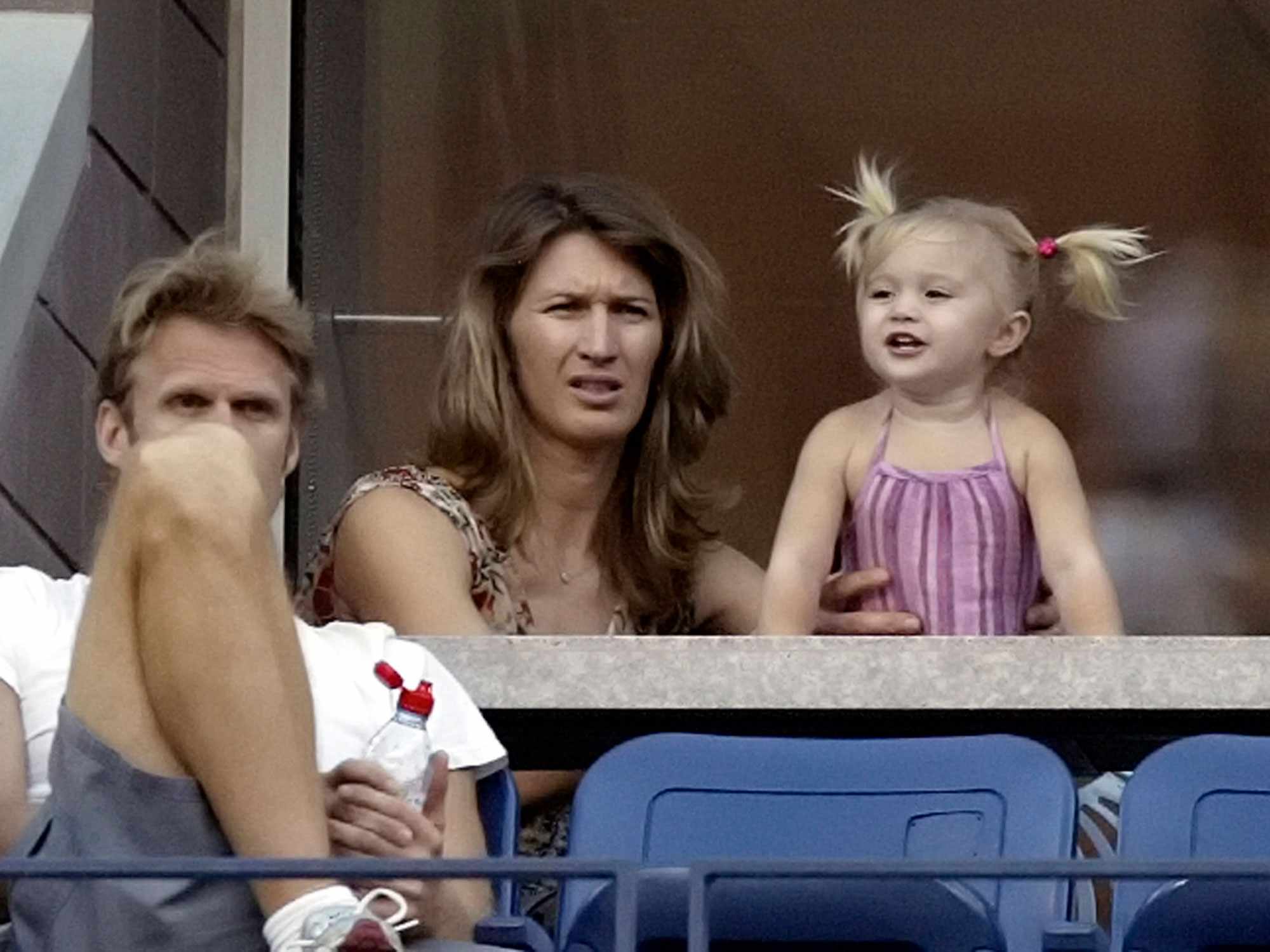 Steffi Graf and her daughter, Jaz Elle, watch the tennis match between Andre Agassi and Tomas Berdych, of the Czech Republic, at the US Open tennis tournament in New York, Saturday, Sept. 3, 2005. Person at left is unidentified. (AP Photo/Greg Bull)