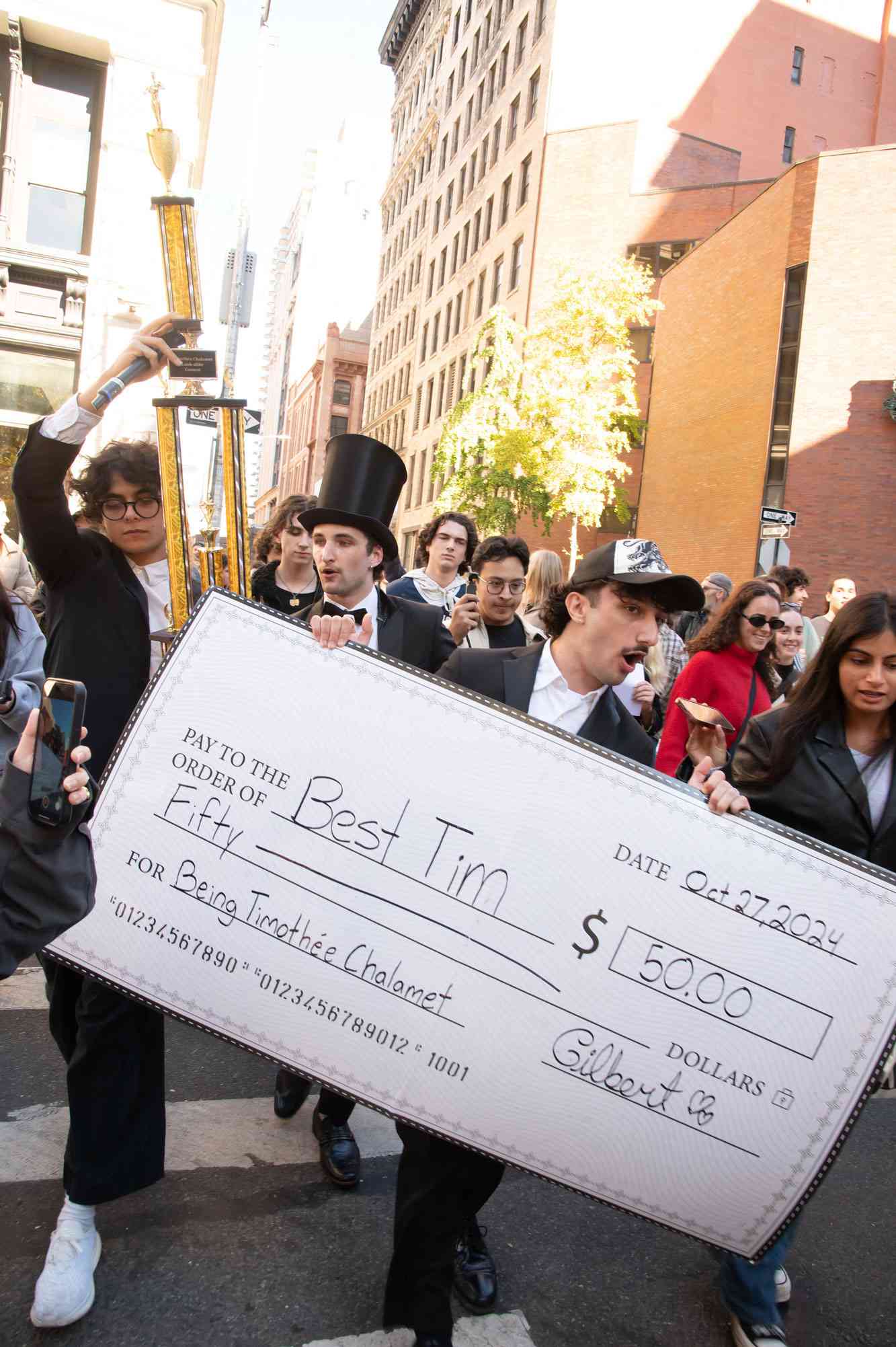 Timothee Chalamet Look-Alike Contest in NYC, Hundreds of NYU Students came out for the contest, which started in Washington Square Park. After being kicked out of the park, the parade continued all around Greenwich Village. $50 prize was for the winner