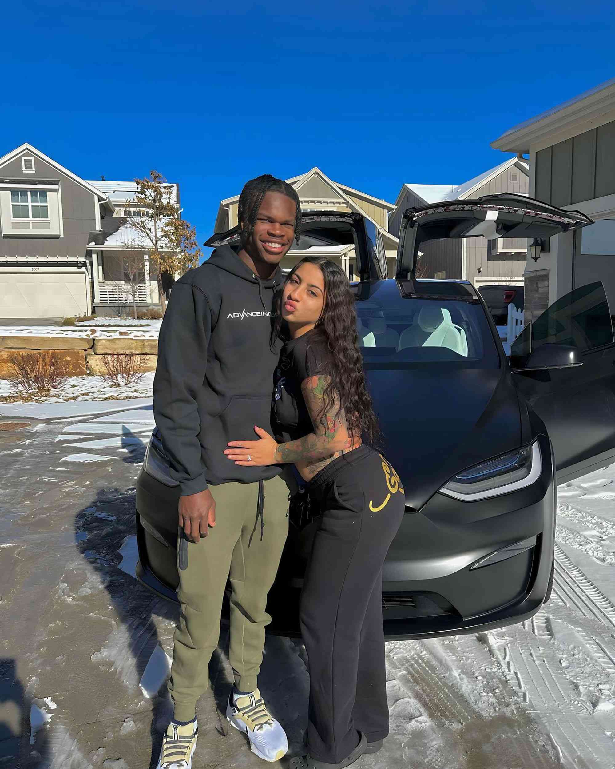 Travis Hunter is with his fiancée, Leanna Lanee, and her new Tesla.