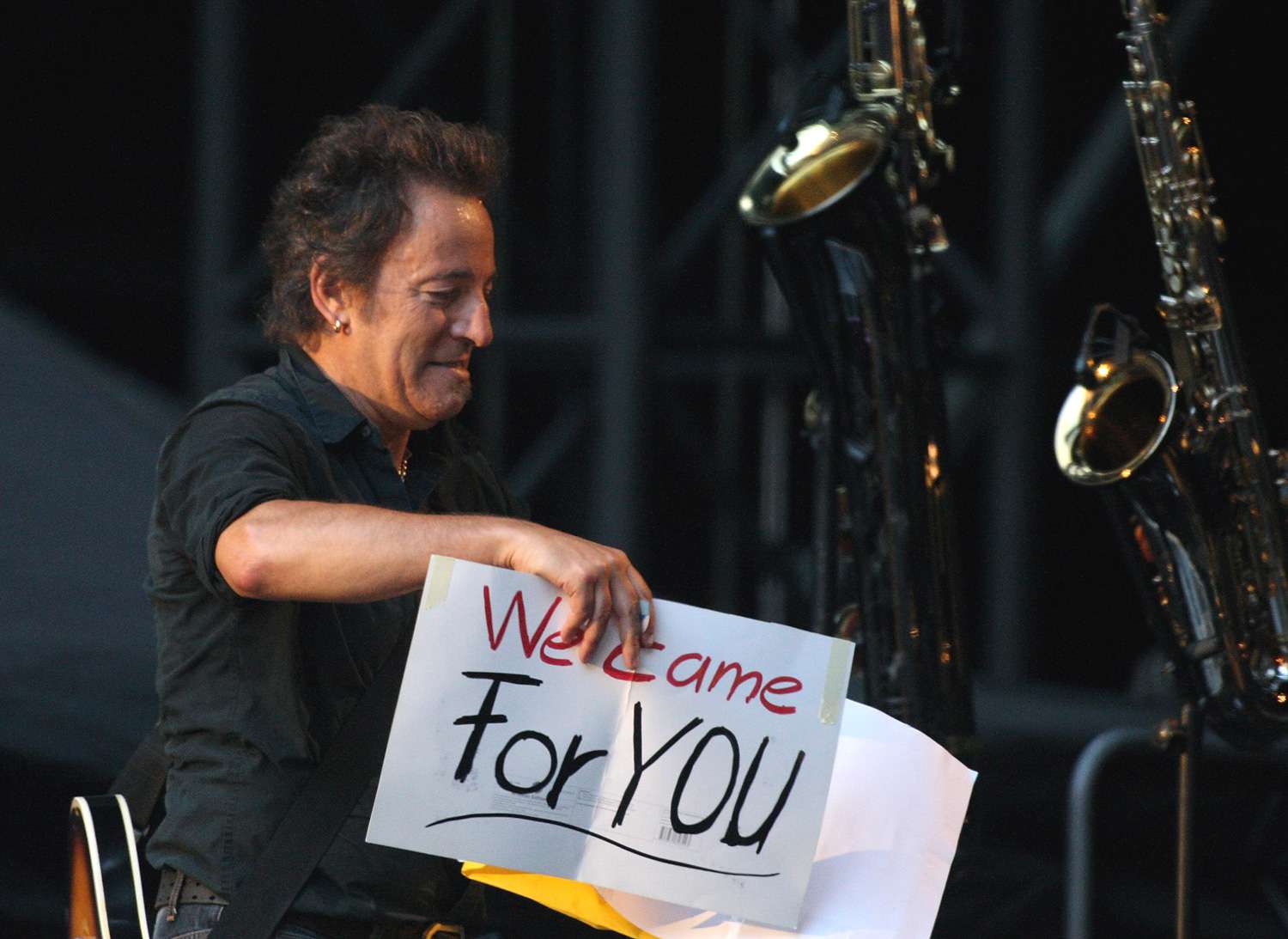 Musician Bruce Sringsteen holds some banners during a live concert at the LTU Arena on June 16, 2008 in Duesseldorf, Germany