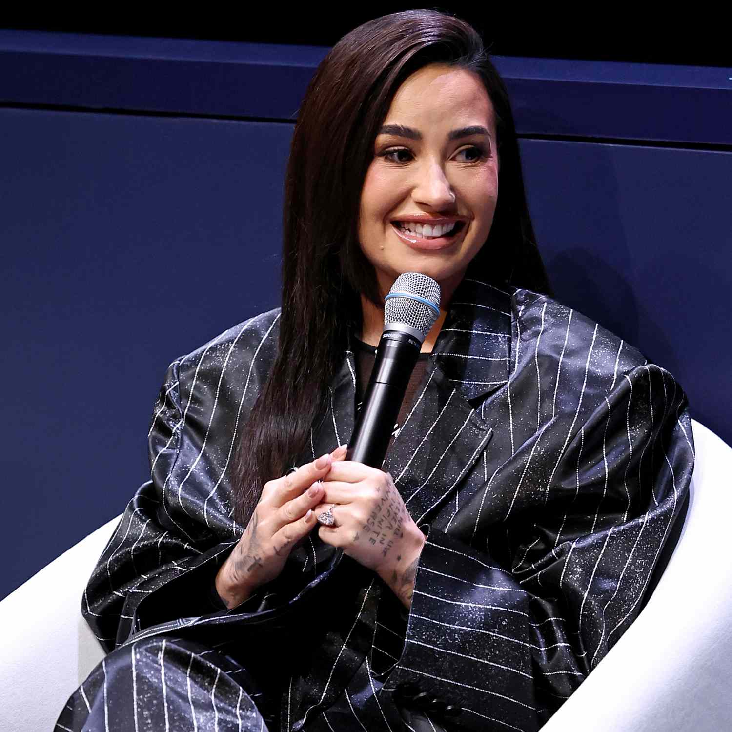 Demi Lovato speaks onstage during the Project Healthy Minds World Mental Health Day Festival at 