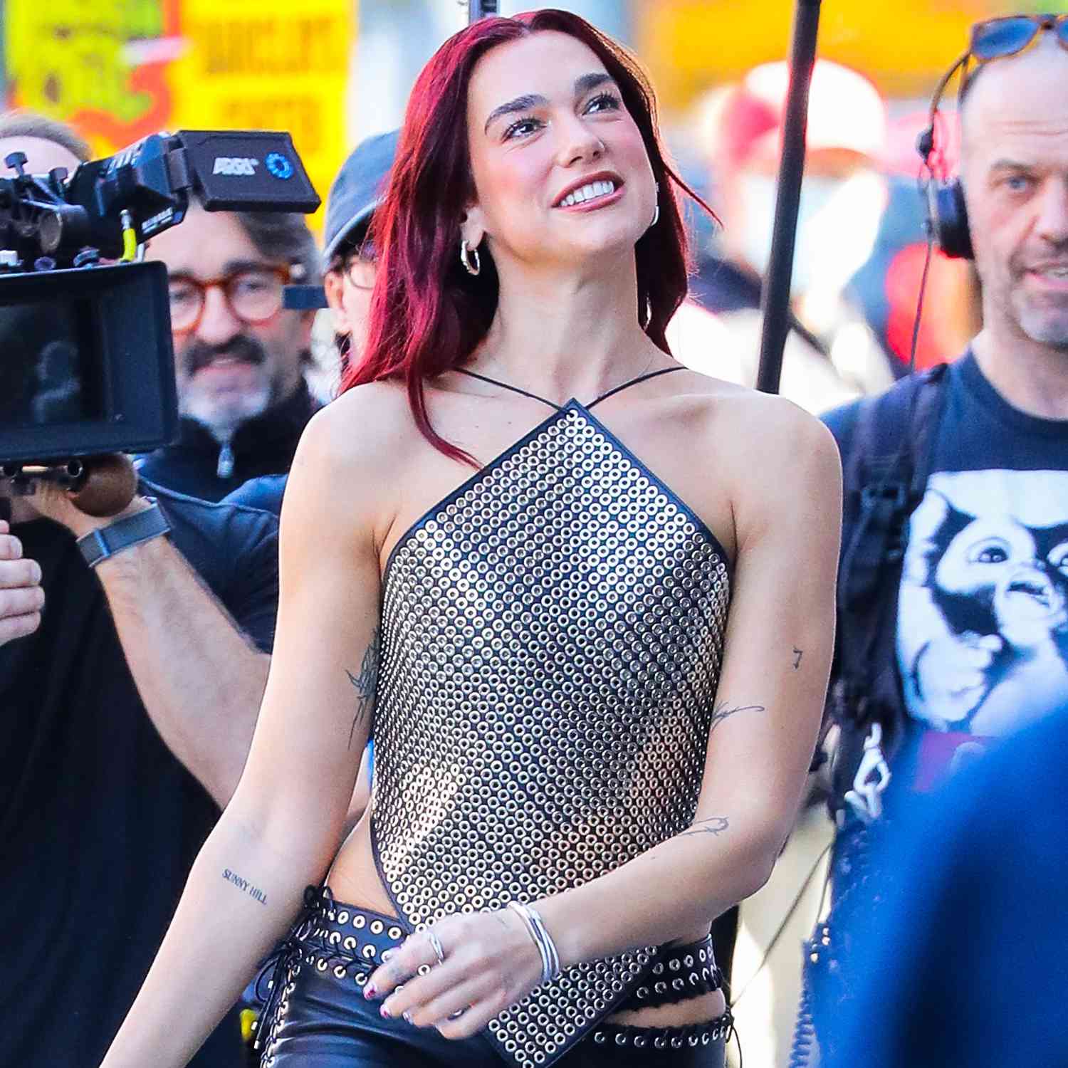 Dua Lipa is spotted beaming on set while filming in New York City, bringing her signature charm and energy to the shoot.