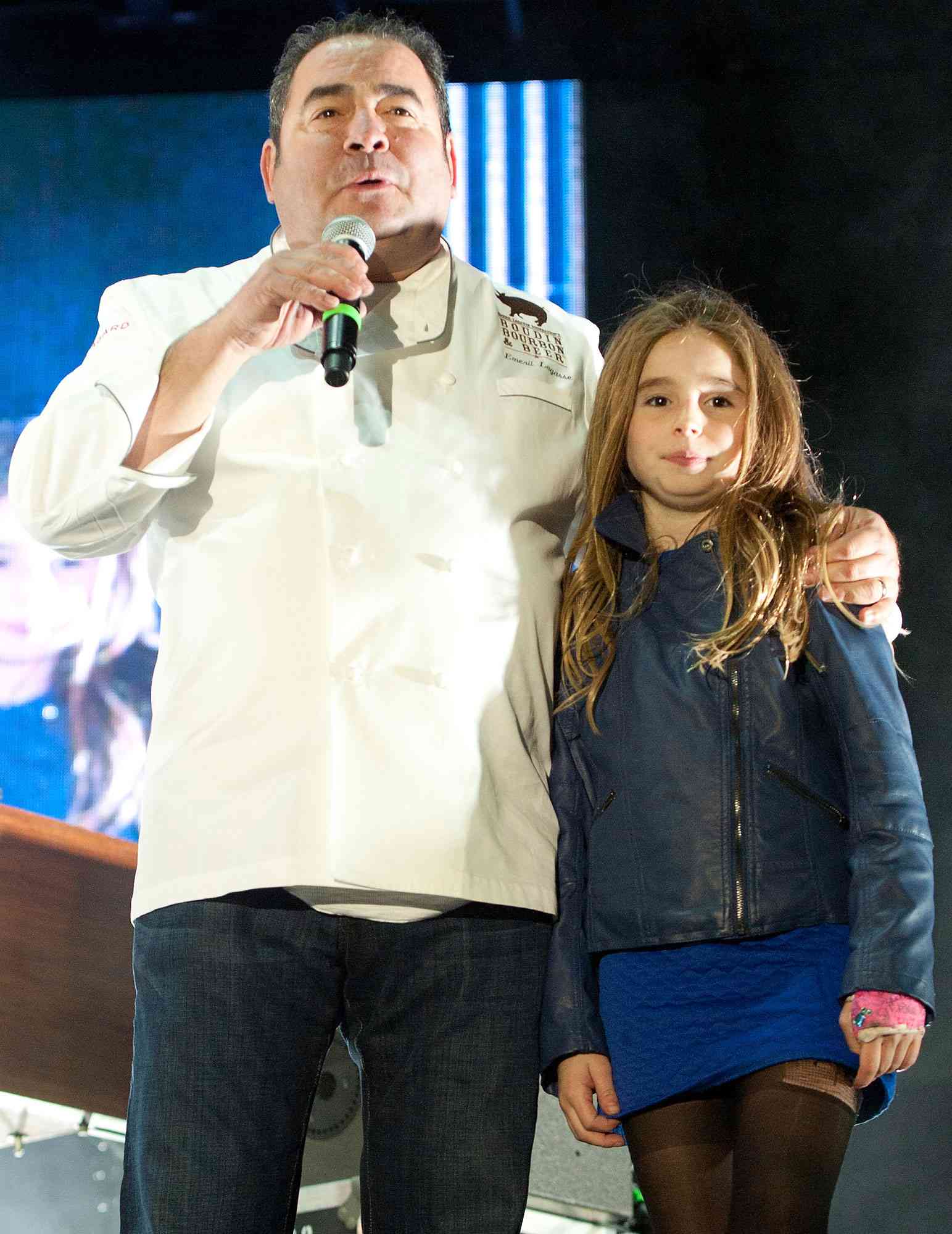 Emeril Lagasse and his daughter thank guests for attending Boudin, Bourbon & Beer at Champions Square on November 7, 2014 in New Orleans, Louisiana.