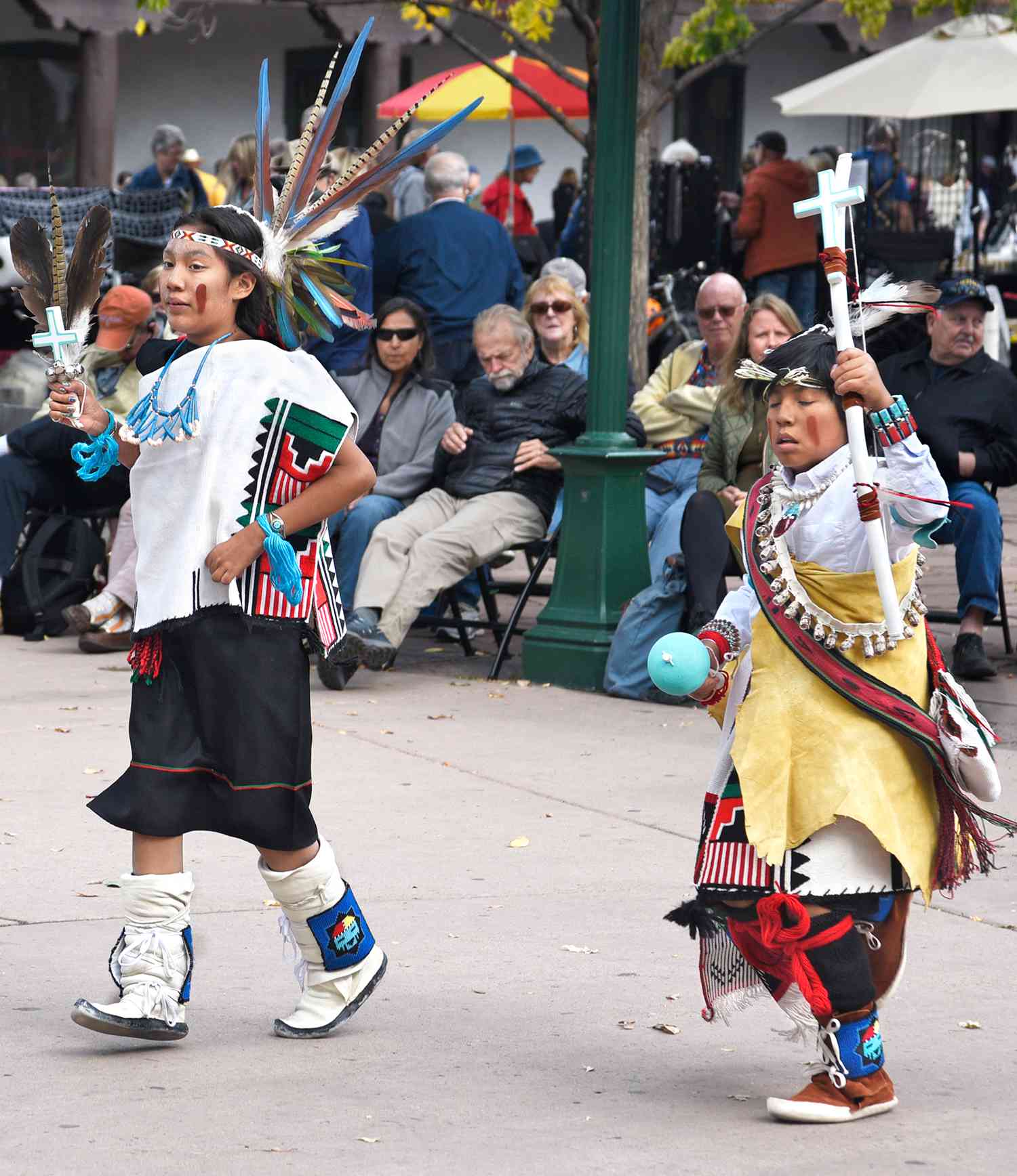 Members of a Native-American dance group from Tesuque Pueblo in New Mexico perform in the historic Plaza in Santa Fe, New Mexico, as part of the city's Indigenous Peoples Day program