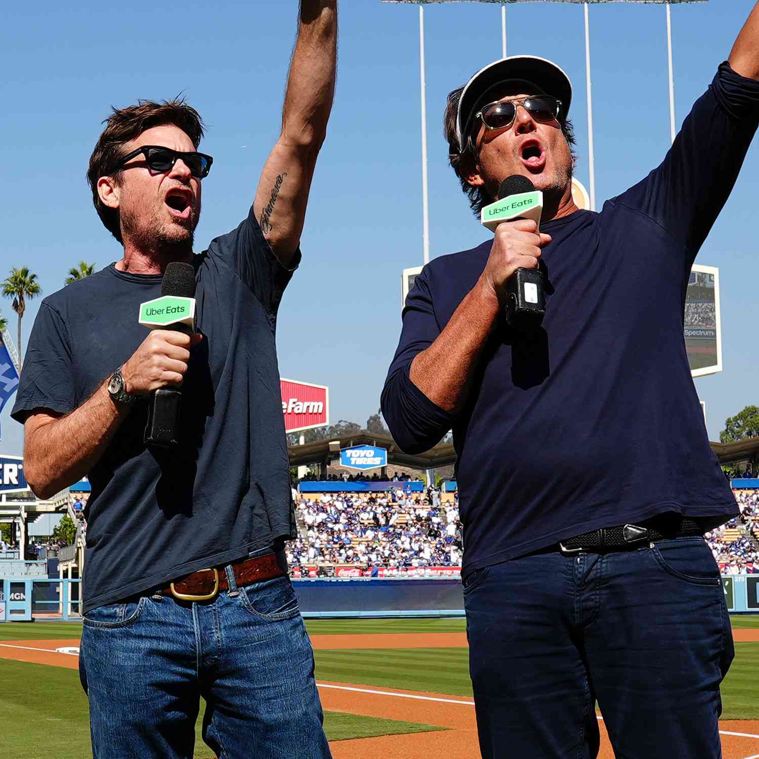  Jason Bateman and Will Arnett talk on the field prior to Game 2 of the NLCS presented by loanDepot between 