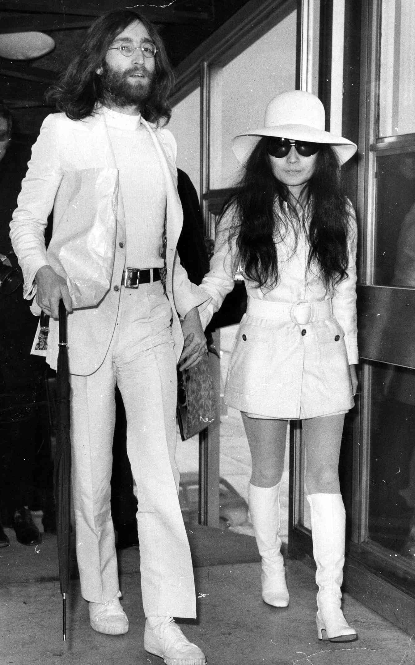 2nd April 1969: Singer and songwriter John Lennon (1940 - 1980) and his wife artist Yoko Ono, both dressed in white at London Airport.