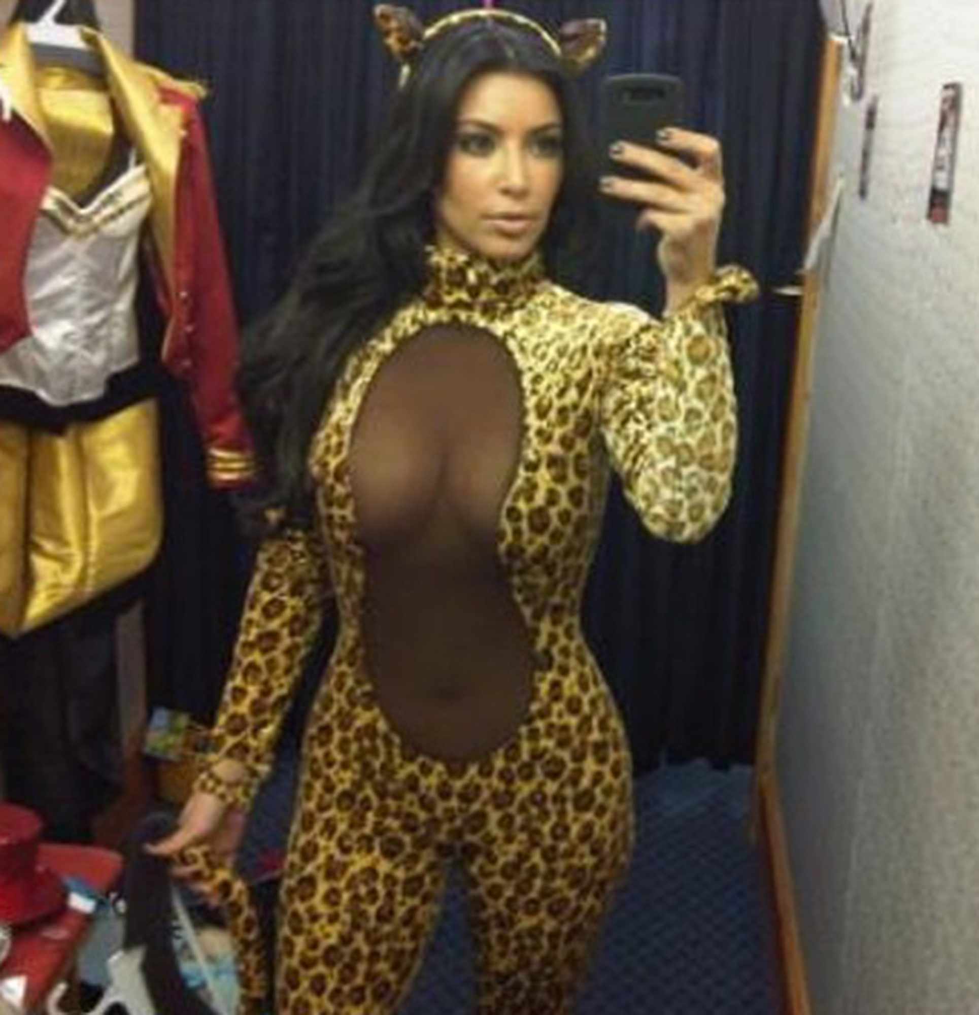 Kim Kardashian takes a mirror selfie dressed in a leopard costume in 2010