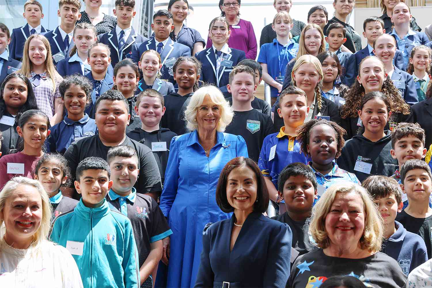 Queen Camilla poses for a group photo with students, authors and representatives from the NSW Government during a visit to the Green Square Library on October 22, 2024 in Sydney, Australia