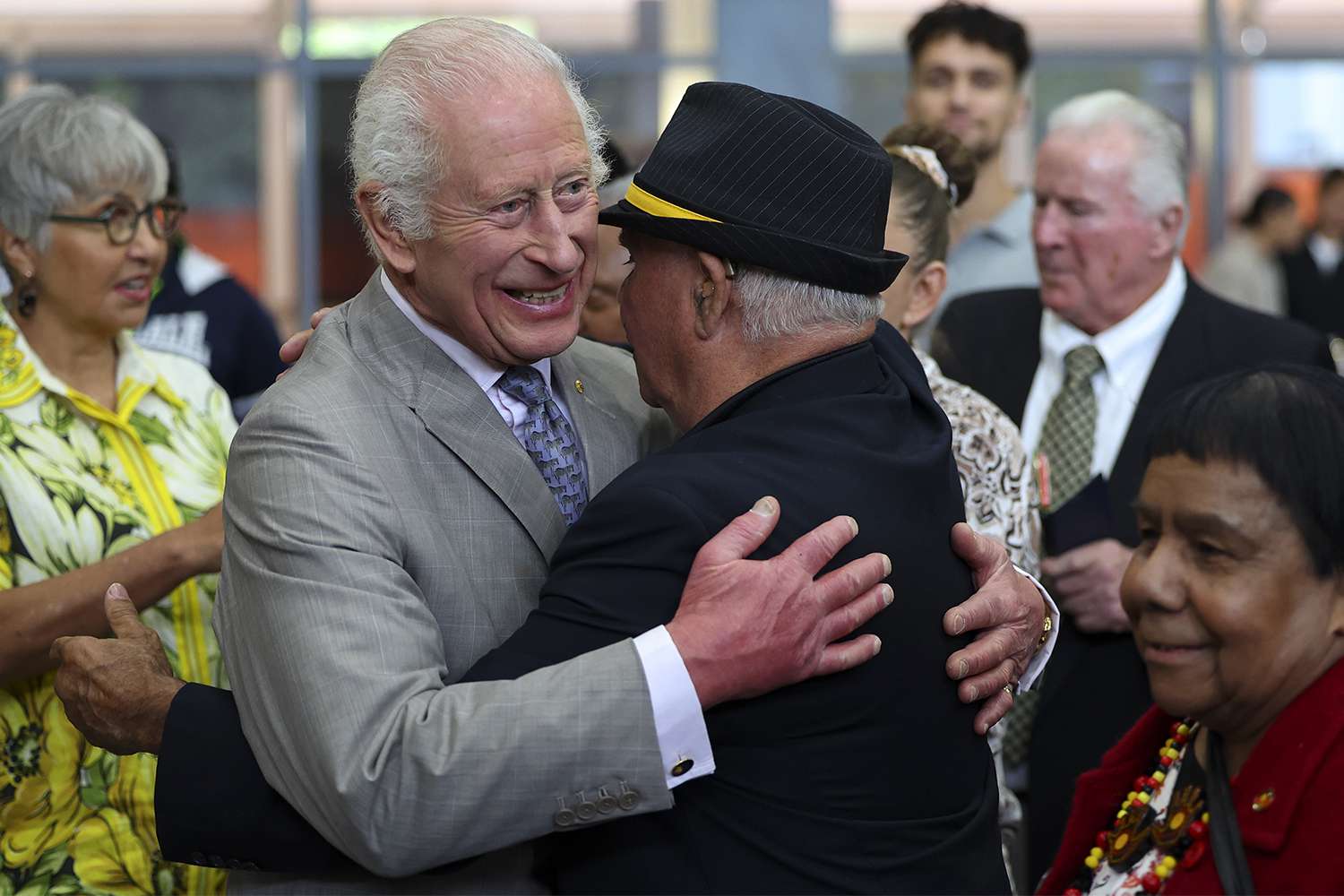 King Charles III embraces a member of the Indigenous community during a visit to the National Centre for Indigenous Excellence on October 22, 2024 in Sydney, Australia.