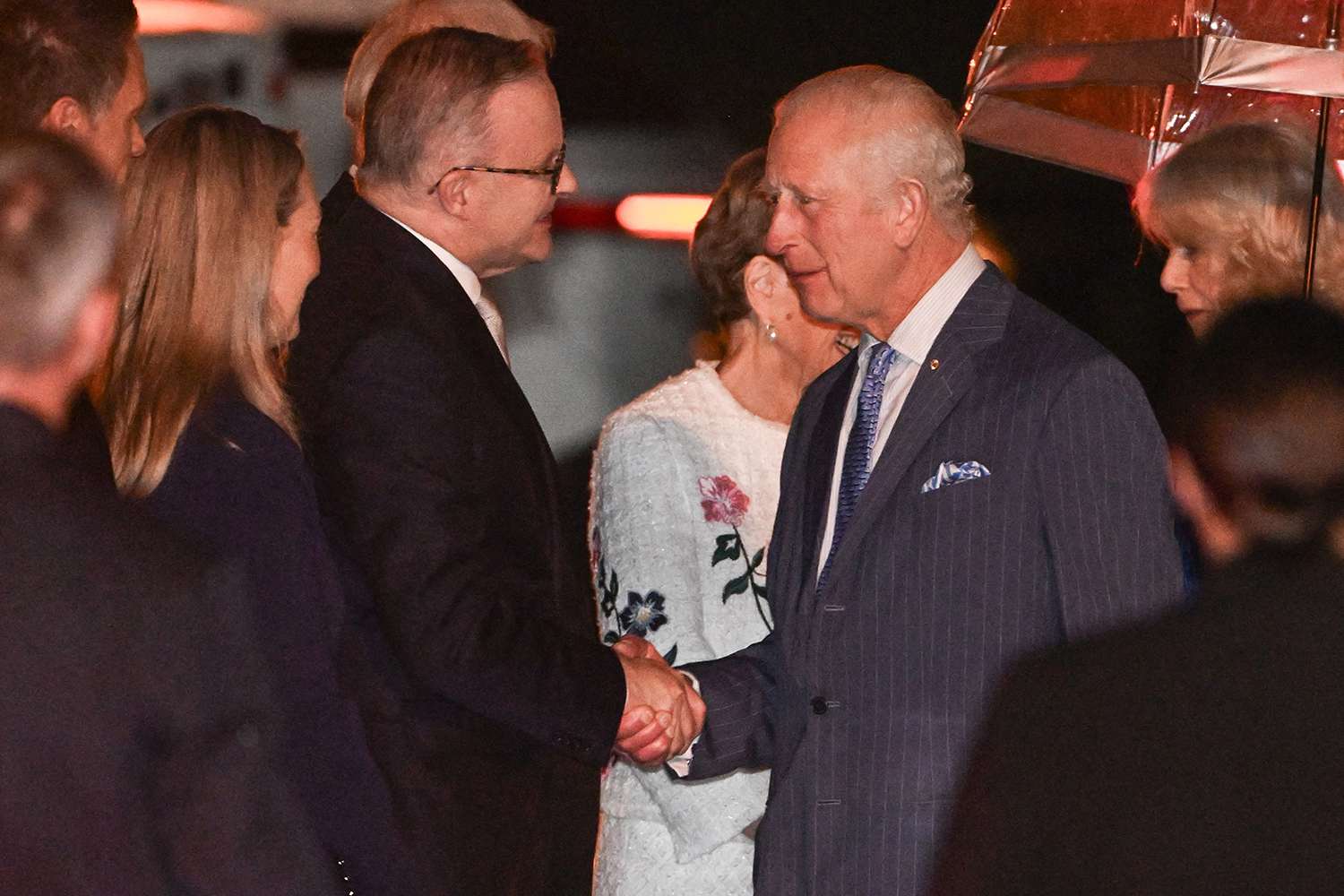 Australia's Prime Minister Anthony Albanese (L) welcomes Britain's King Charles III (centre R) and Queen Camilla (2nd R) upon their arrival at Sydney International Airport in Sydney