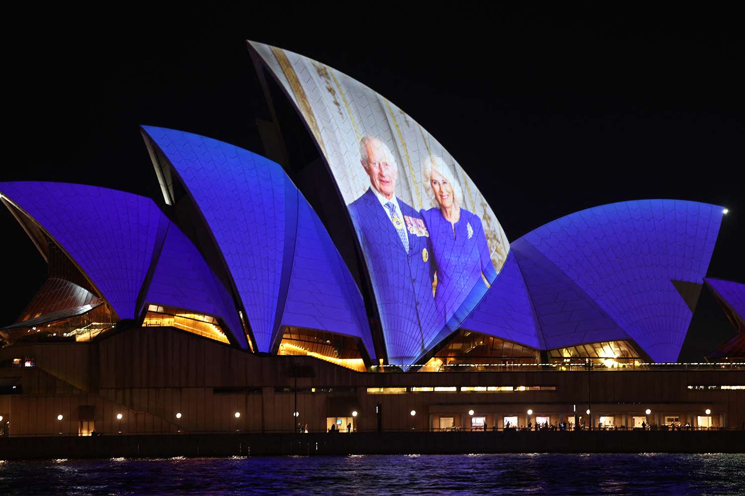 A projection of a photograph of Britain's King Charles III and Queen Camilla is seen on the Sydney Opera House in Sydney on October 18, 2024