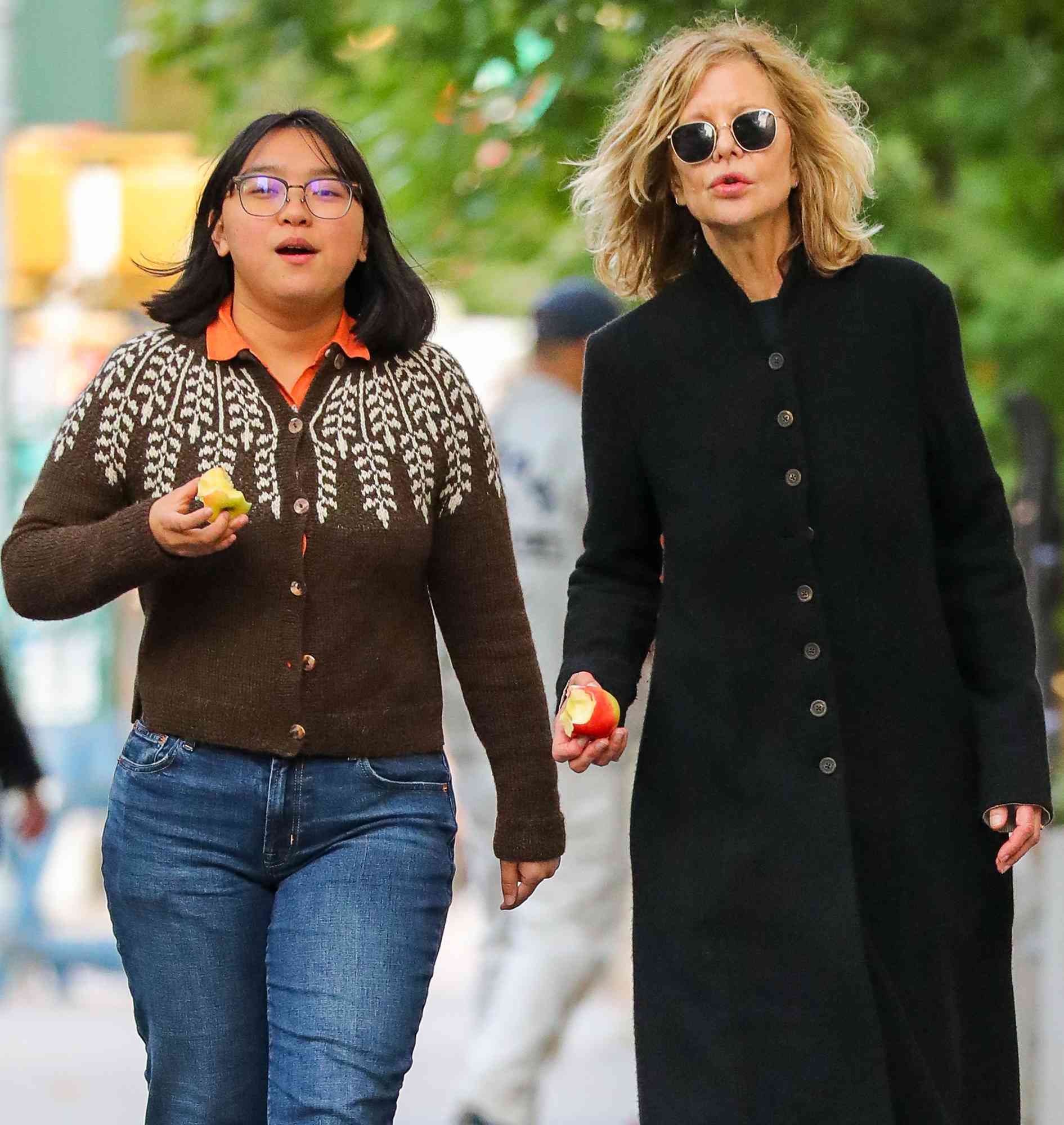 Meg Ryan is spotted on a rare outing with her daughter in New York City. The 62 year old American actress who was dressed casually in a long wool coat over denim jeans was joined by her 20 year old daughter Daisy. The duo appeared to be enjoying apples while on their stroll.