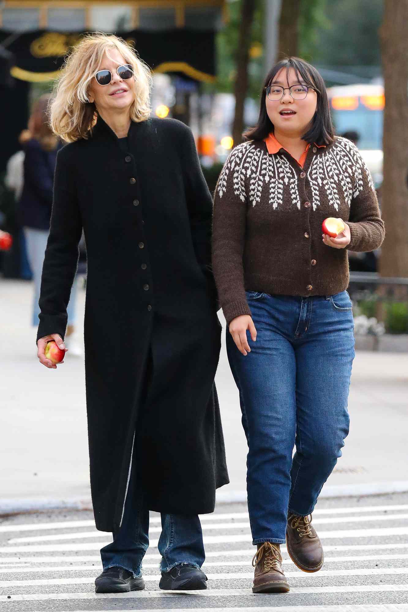 Meg Ryan is spotted on a rare outing with her daughter in New York City. The 62 year old American actress who was dressed casually in a long wool coat over denim jeans was joined by her 20 year old daughter Daisy. The duo appeared to be enjoying apples while on their stroll.