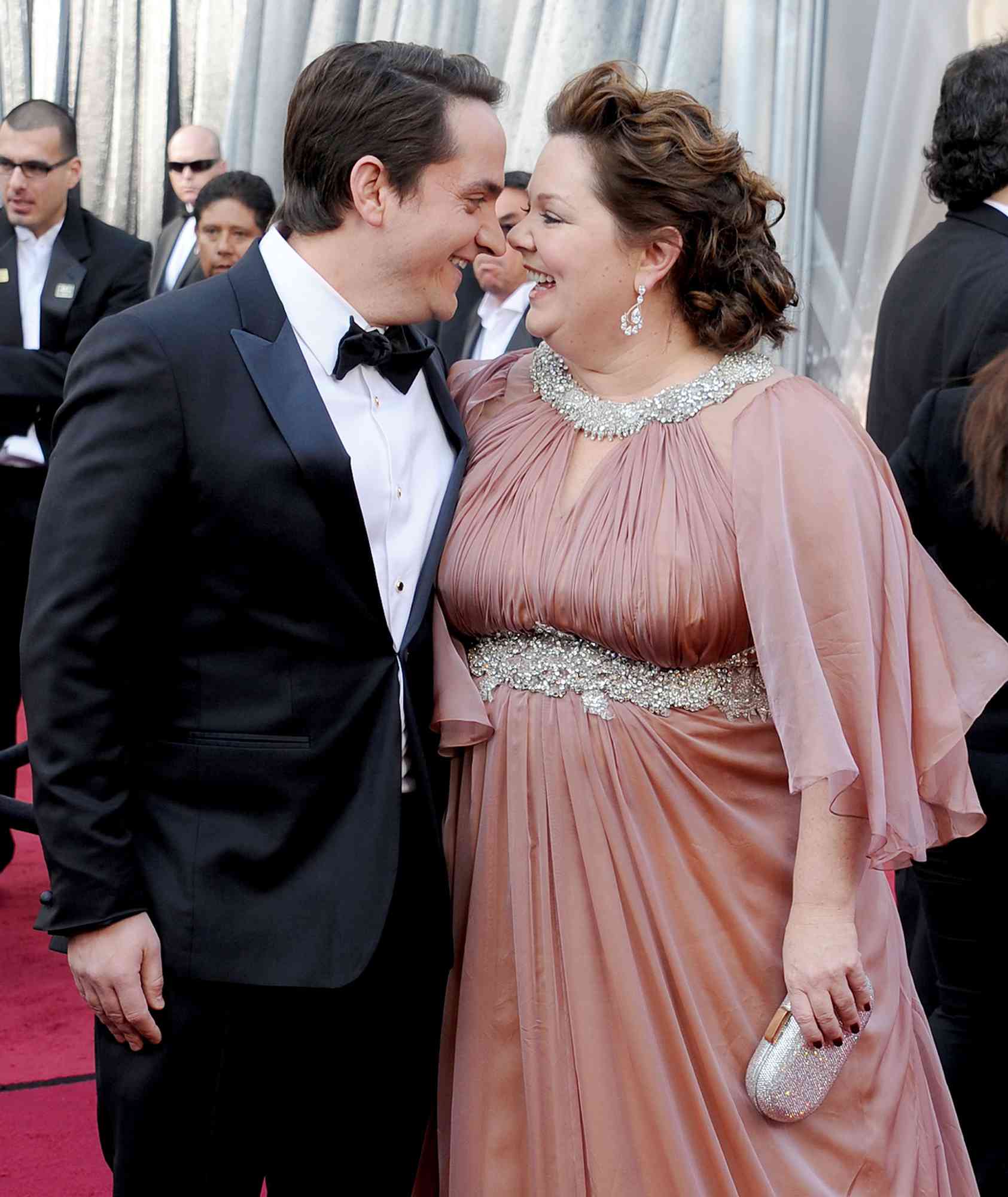 Melissa McCarthy (R) and husband Ben Falcone arrive at the 84th Annual Academy Awards at Hollywood & Highland Center on February 26, 2012 in Hollywood, California