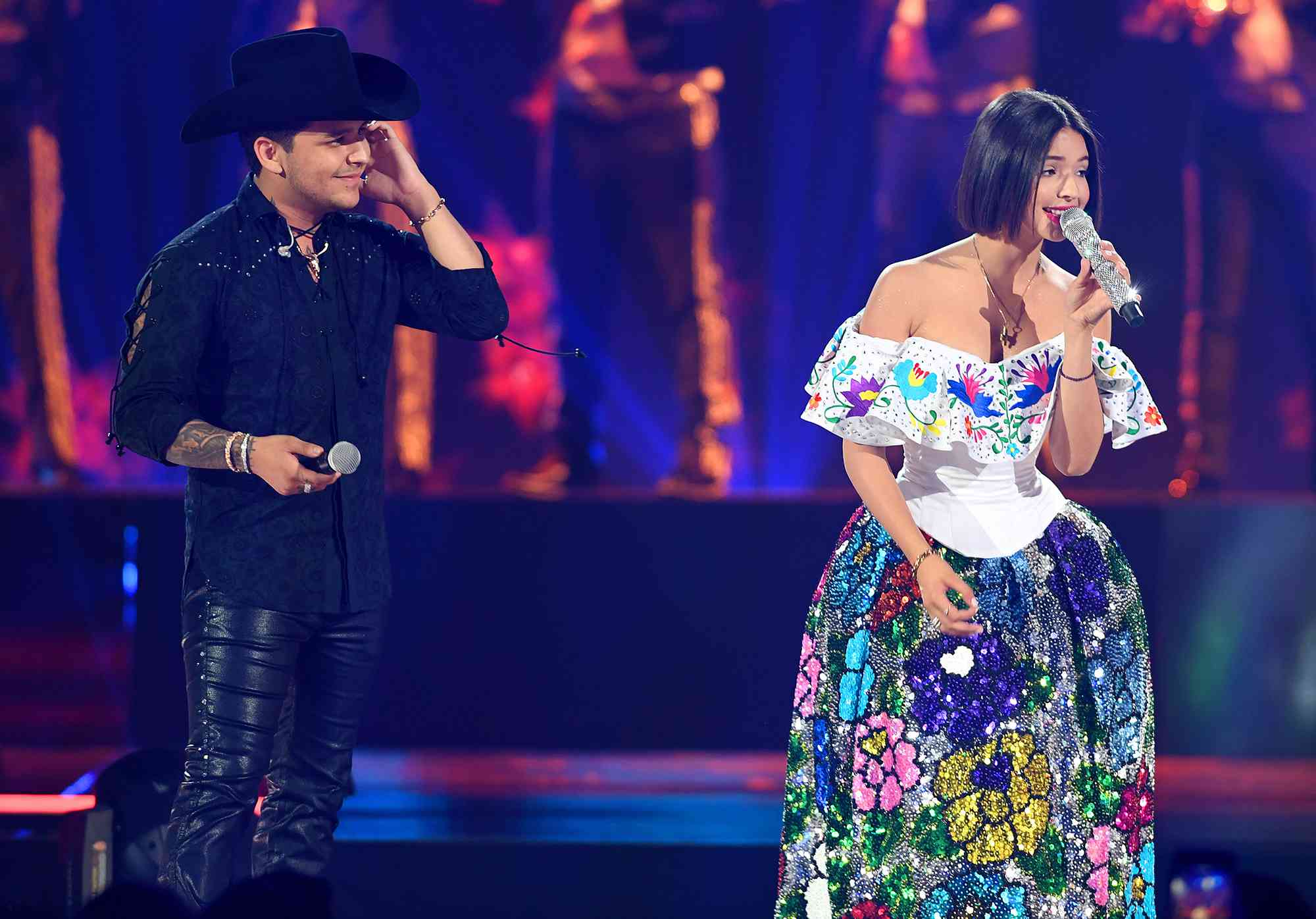 Christian Nodal and Angela Aguilar perform on stage during Premios Juventud 2019 at Watsco Center on July 18, 2019 in Coral Gables, Florida. 