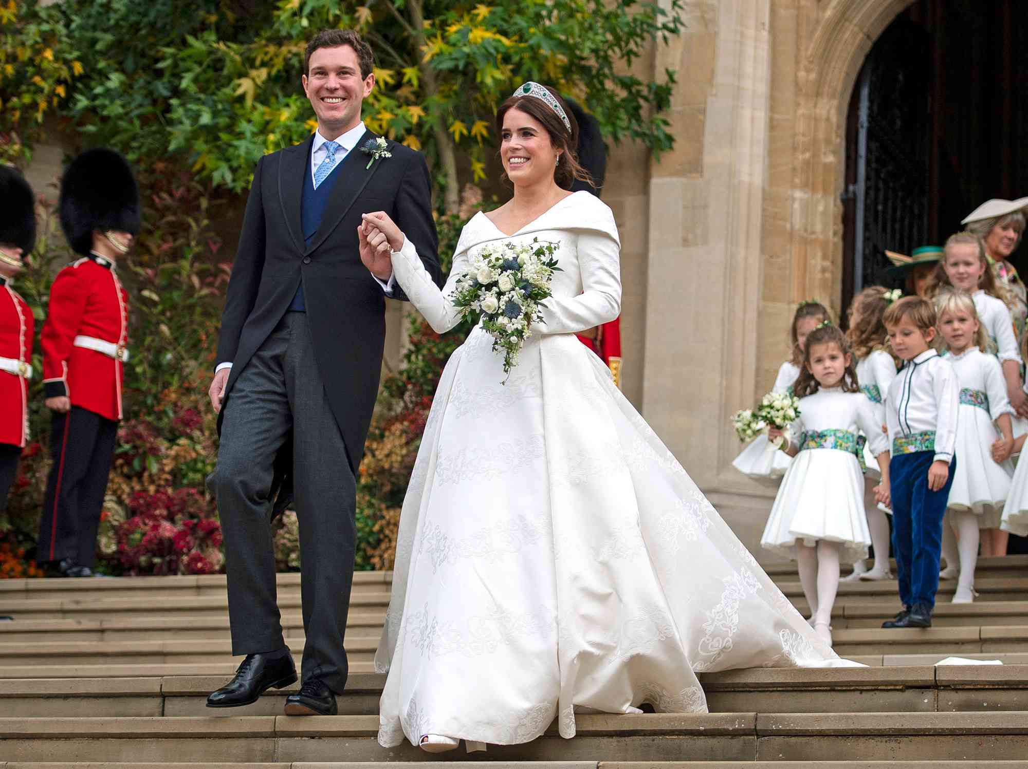 Princess Eugenie of York and Jack Brooksbank leave St George's Chapel in Windsor Castle following their wedding at St. George's Chapel on October 12, 2018 in Windsor, England