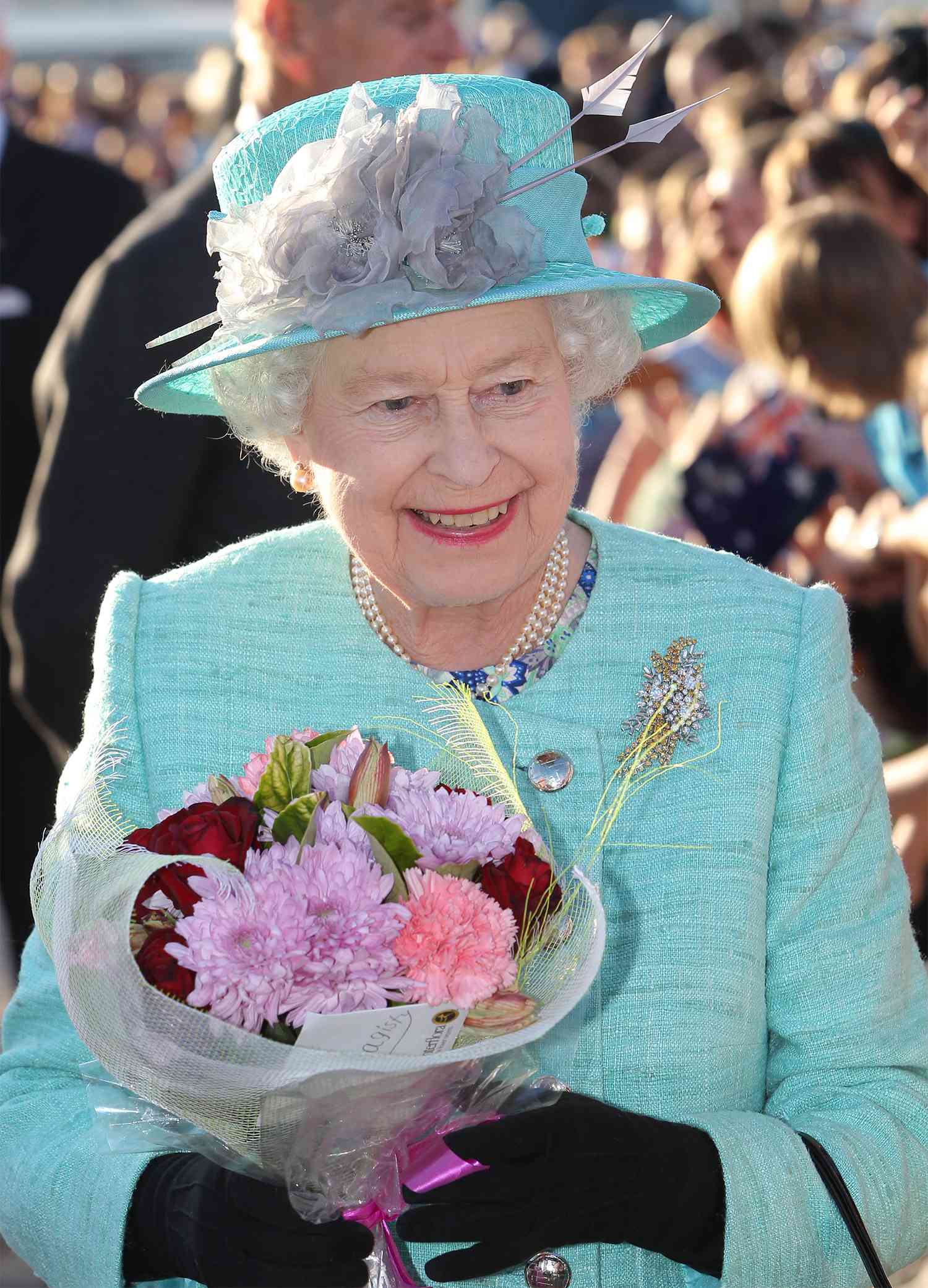 Queen Elizabeth II greets the crowds on arrival at Fairbairn base on October 19, 2011 in Canberra, Australia.