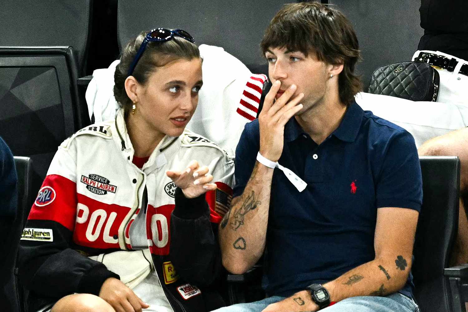 Emma Chamberlain (L) and Us singer and songrwriter Peter McPoland attend the artistic gymnastics women's qualification during the Paris 2024 Olympic Games