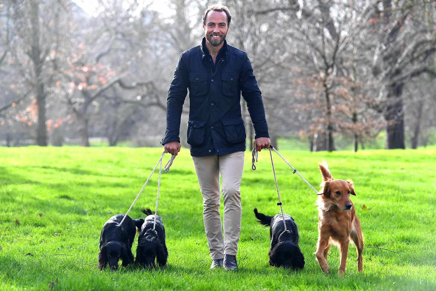  James Middleton poses for a photograph with his dogs Inka, Luna, Ella and Mabel.