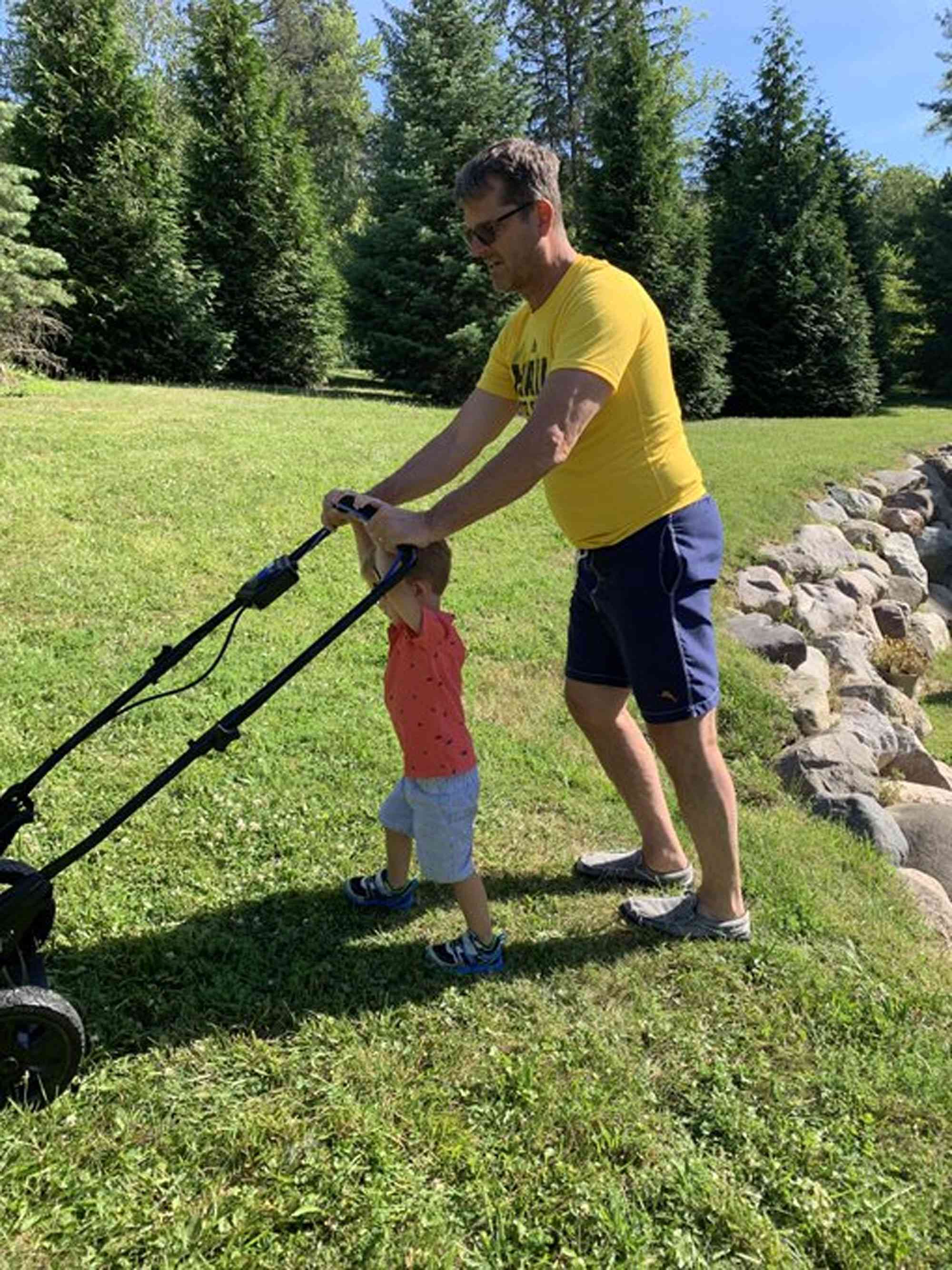 Jim Harbaugh is cutting the grass with his son, John.