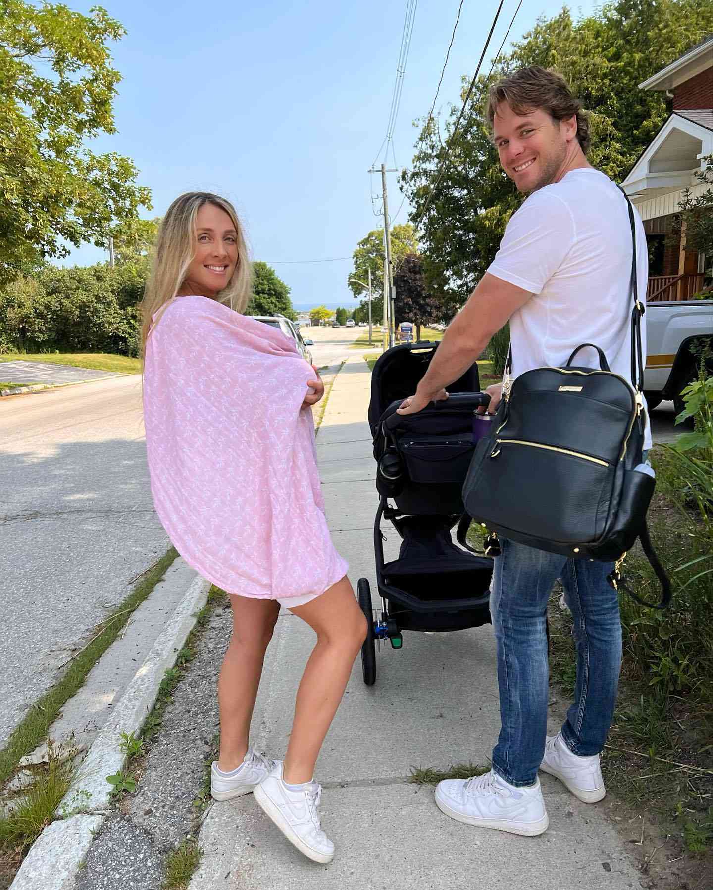 Lisa Marie Holmes and husband Mike on a stroll with their new baby girl, Azura.