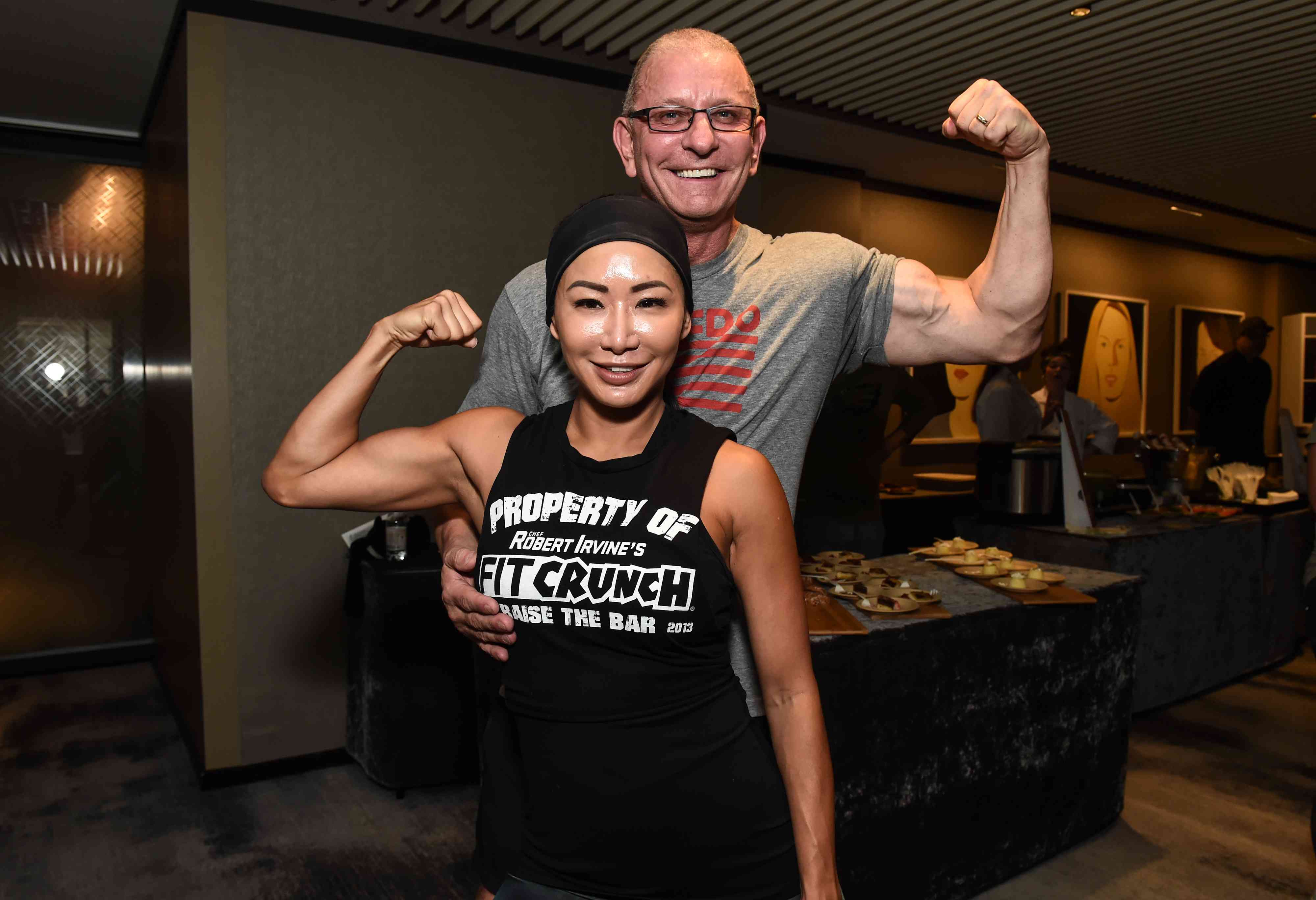 Robert Irvine and wife Gail Kim pose during Fit & Feast presented by Chateau D'Esclans hosted by Robert Irvine and Monique Crous sponsored by Hungry Girl during Food Network & Cooking Channel New York City Wine & Food Festival presented by Capital One at The Langham New York on October 12, 2019 in New York City.