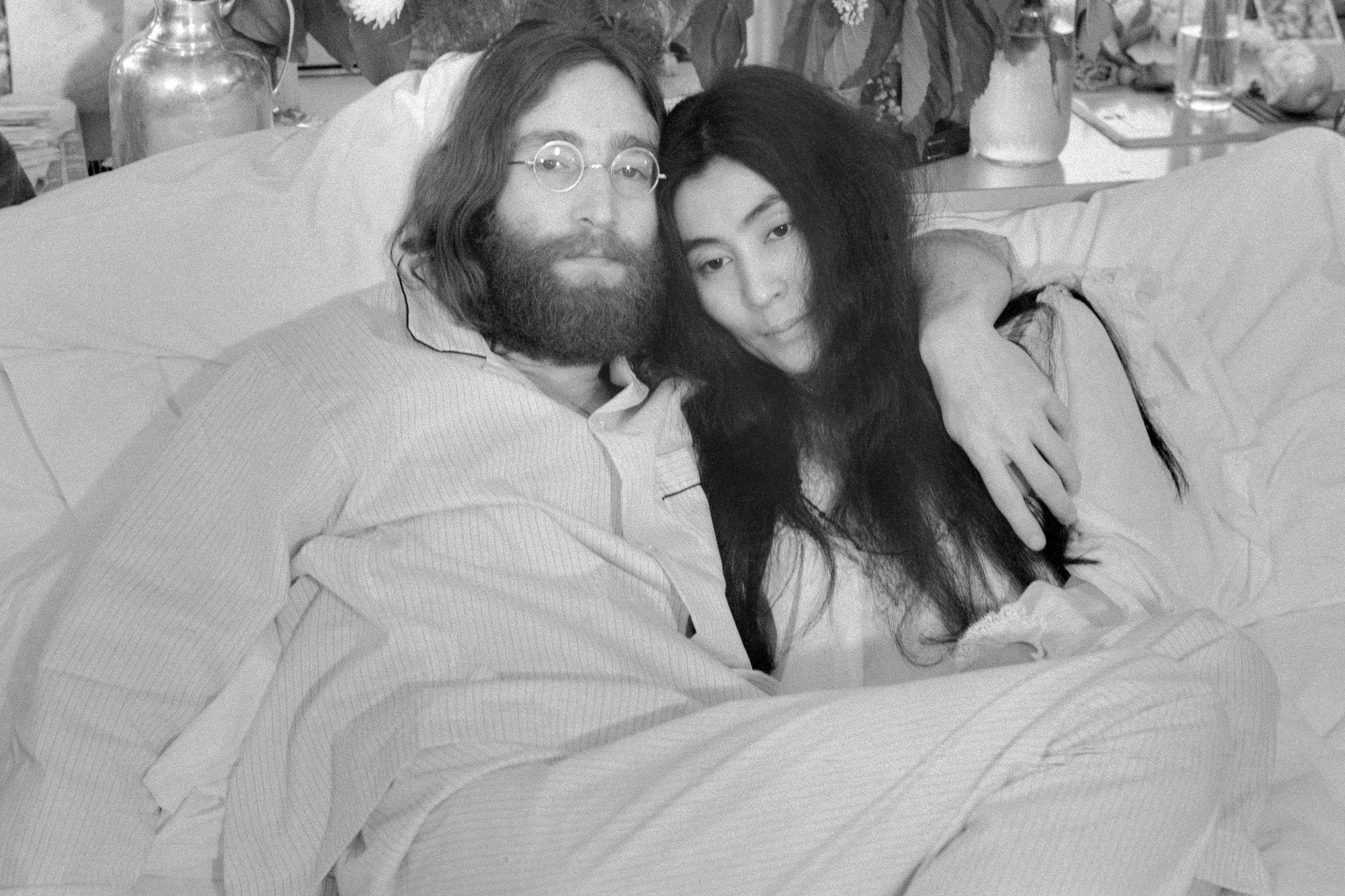 Yoko and John...Beatle John Lennon and Yoko Ono, his bride of three months at the time this photo was made in Montreal in June 1969, pose in bed. His first solo album at the time featured songs telling of his love for Yoko.