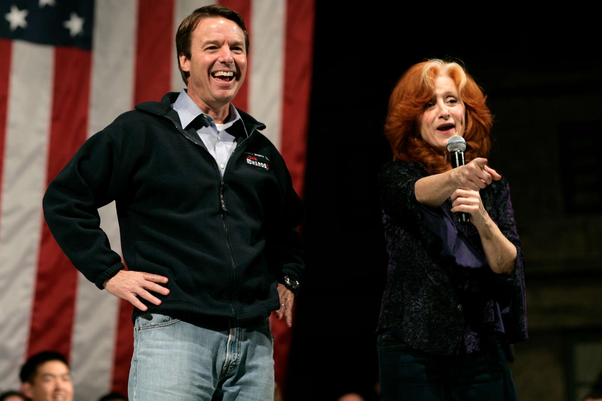 Musician Bonnie Raitt stands beside Democratic Presidential candidate John Edwards, as she performs in his support at a concert in Manchester, New Hampshire.