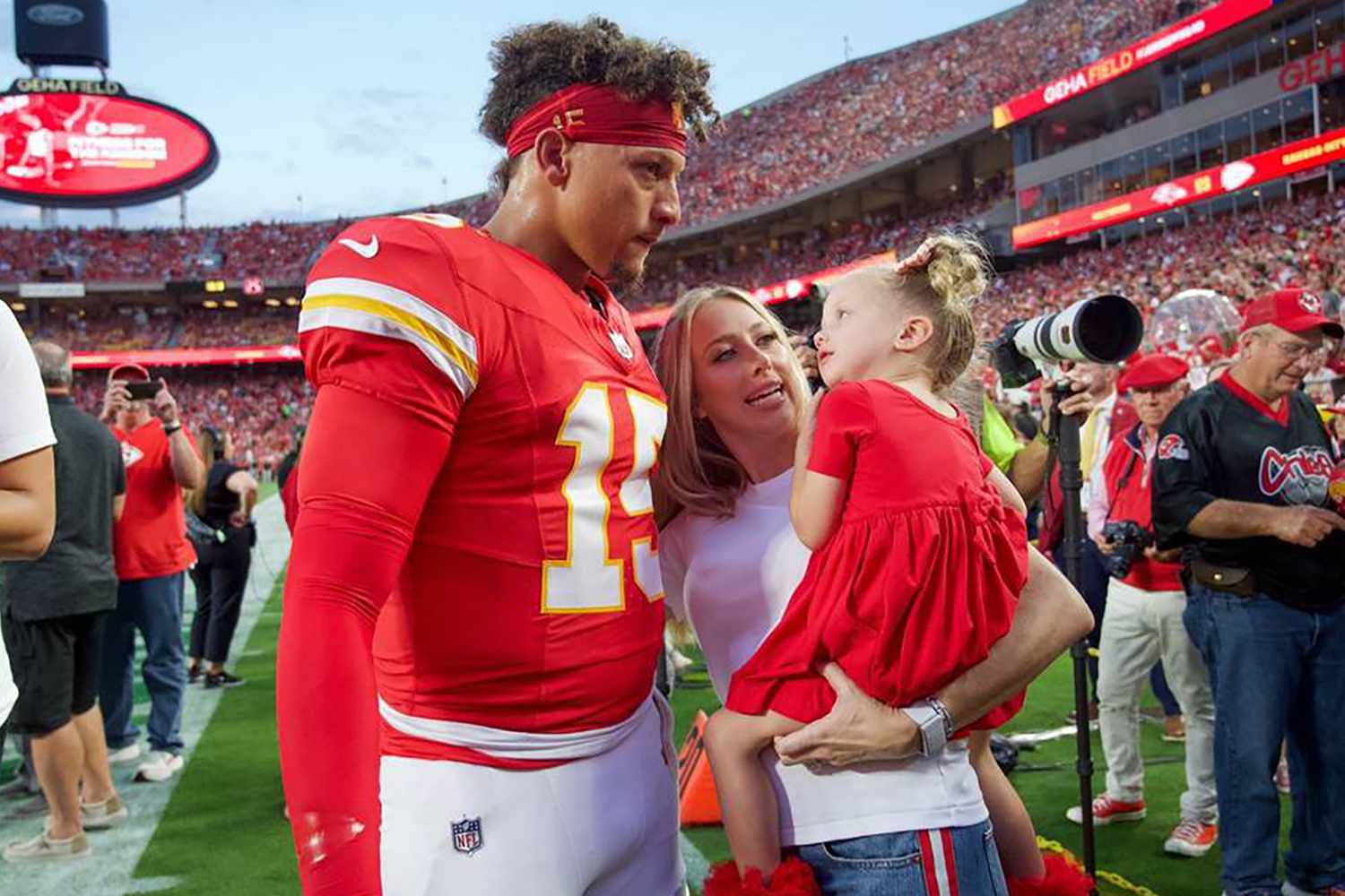 Kansas City Chiefs quarterback Patrick Mahomes visits his wife Brittany and daughter Sterling on the sidelines before the home opener with the Baltimore Ravens on Sept. 5, 2024, at GEHA Field at Arrowhead Stadium in Kansas City, Missouri.