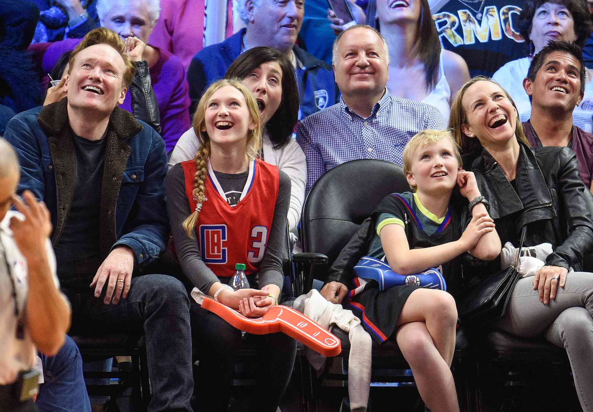 Conan O'Brien, Neve O'Brien, Beckett O'Brien and Liza Powel attend a basketball game between the Houston Rockets and the Los Angeles Clippers on January 18, 2016 in Los Angeles, California. 