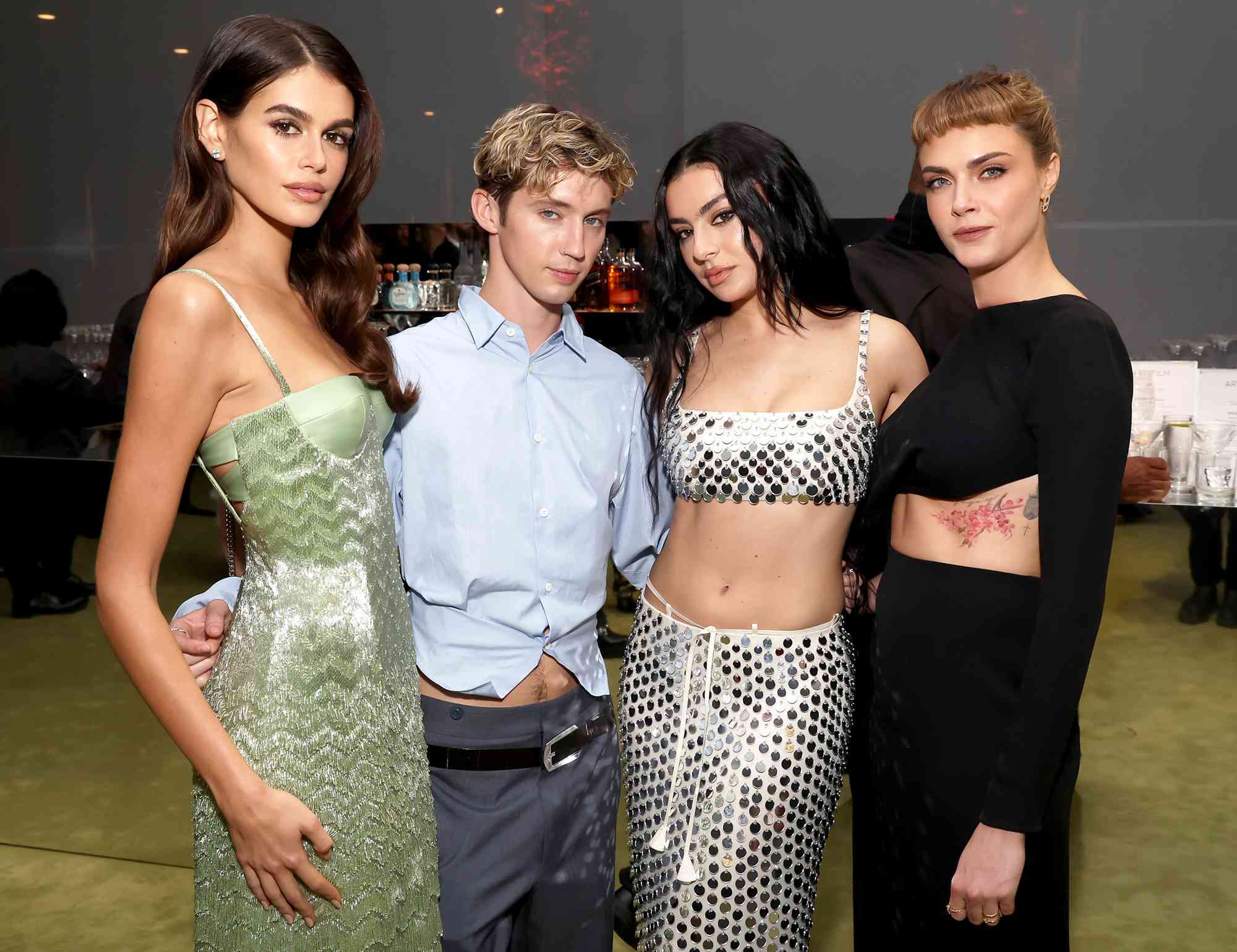 aia Gerber, wearing Gucci, Troye Sivan, Charli XCX, wearing Gucci, and Cara Delevingne, wearing Gucci, attend the 2024 LACMA Art+Film Gala, Presented By Gucci at Los Angeles County Museum of Art on November 02, 2024 in Los Angeles, California. 