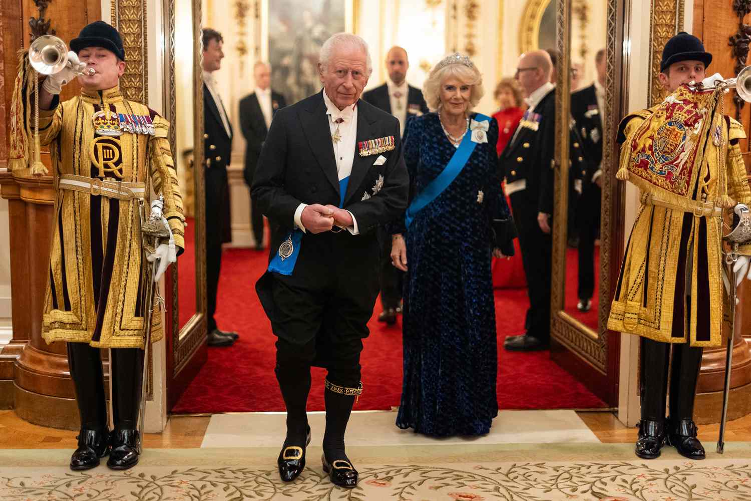 Britain's King Charles III and Britain's Queen Camilla arrive to meet with guests during a reception for members of the Diplomatic Corps at Buckingham Palace in London, on November 19, 2024.