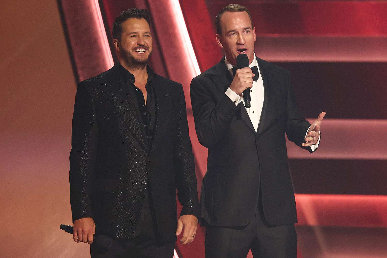 Luke Bryan and Peyton Manning speak onstage at The 57th Annual CMA Awards 