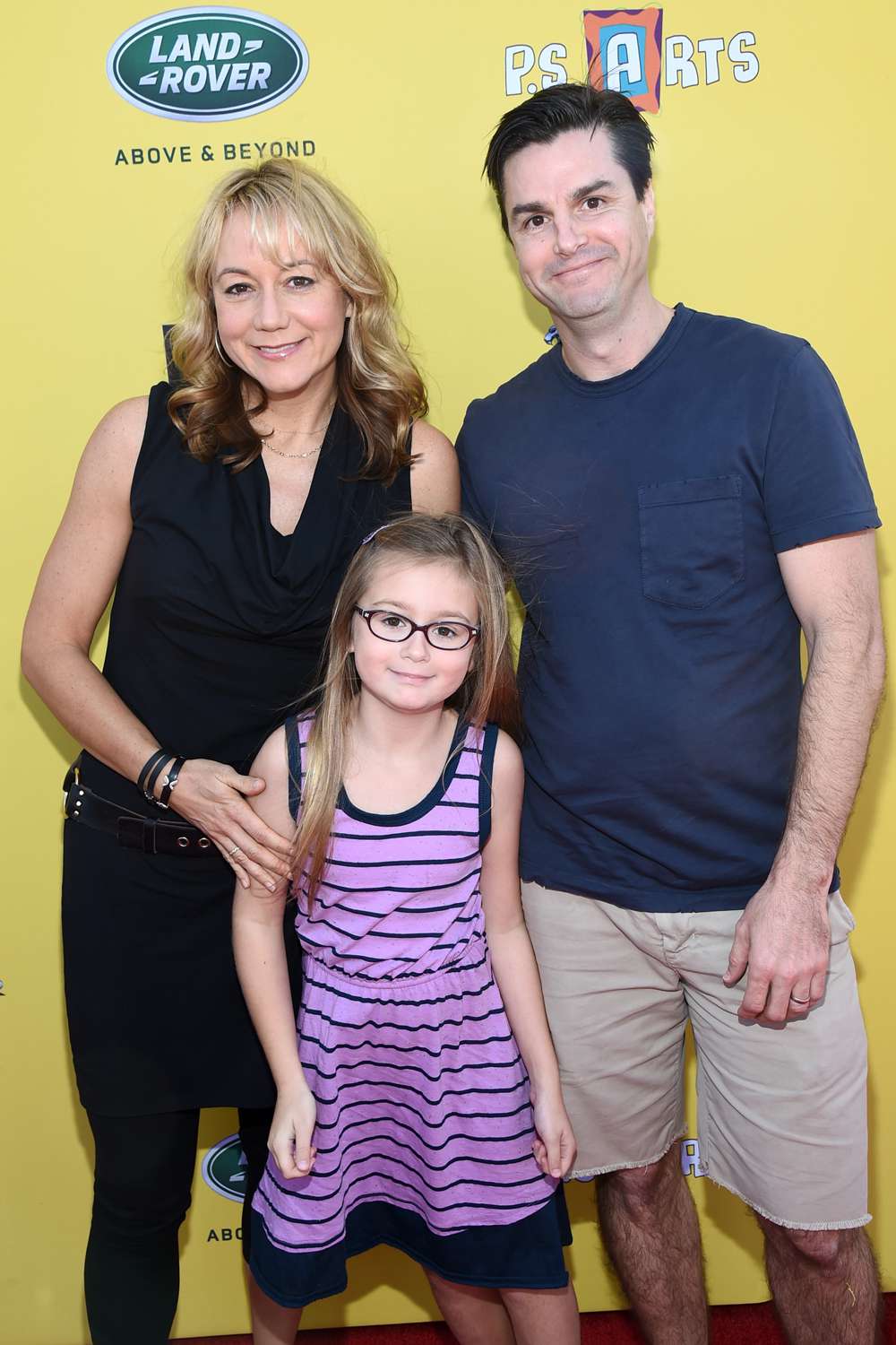 Actress Megyn Price, Grace Price and Edward Cotner attend P.S. ARTS presents Express Yourself 2014 with sponsors OneWest Bank and Jaguar Land Rover at Barker Hangar on November 16, 2014 in Santa Monica, California.